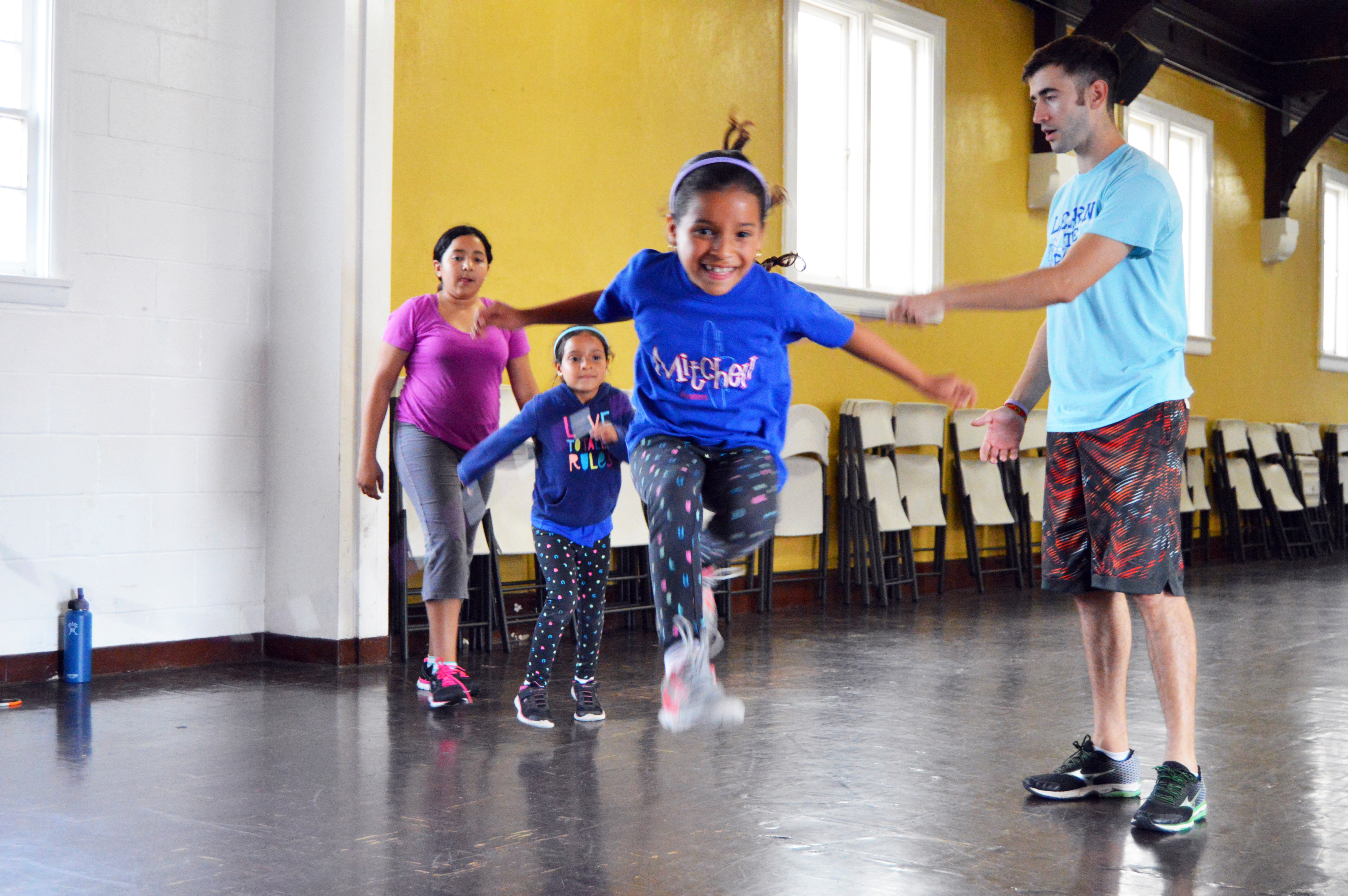 a group of young girls practice jump roping