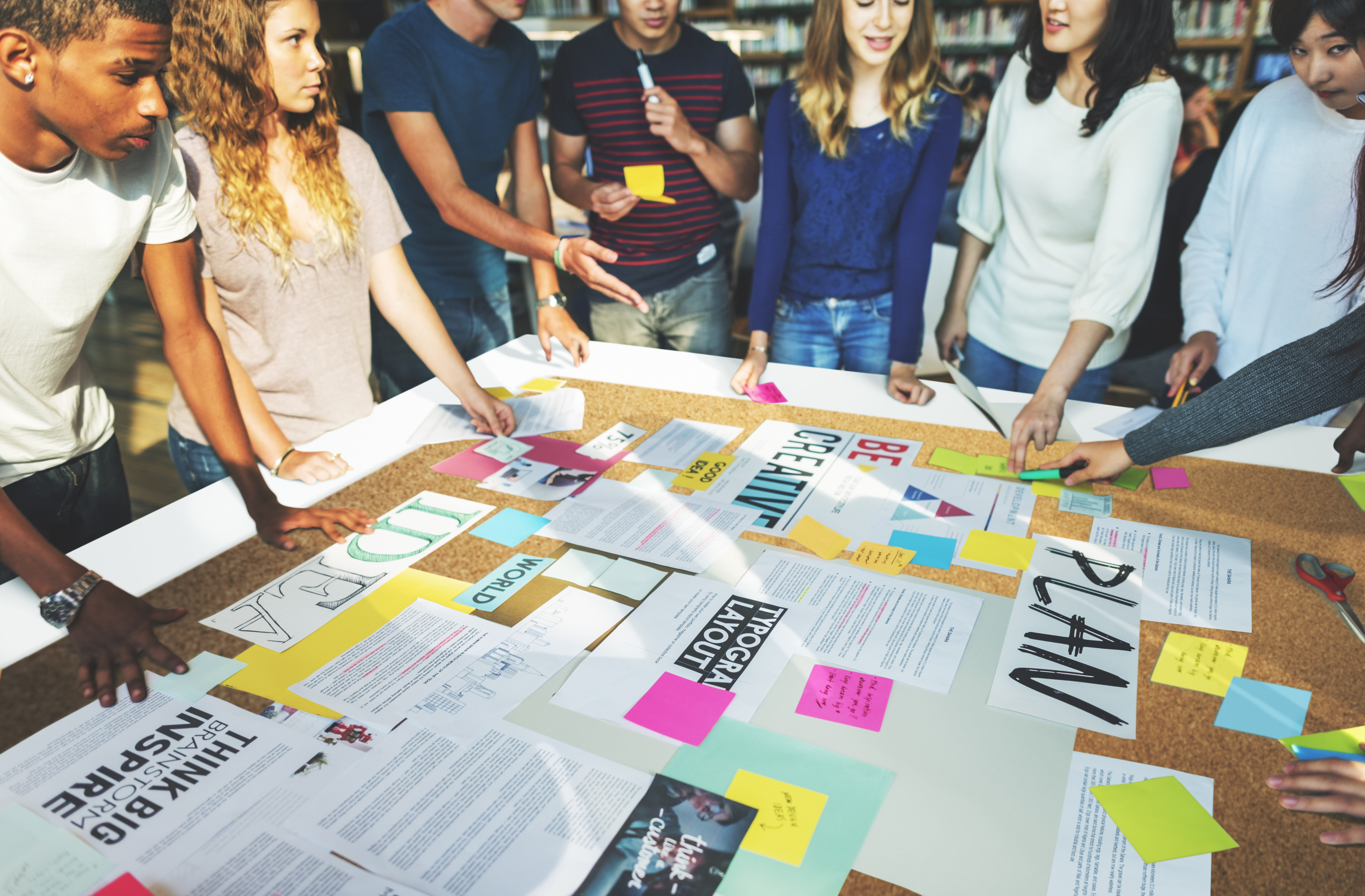 a group collaborates around a table