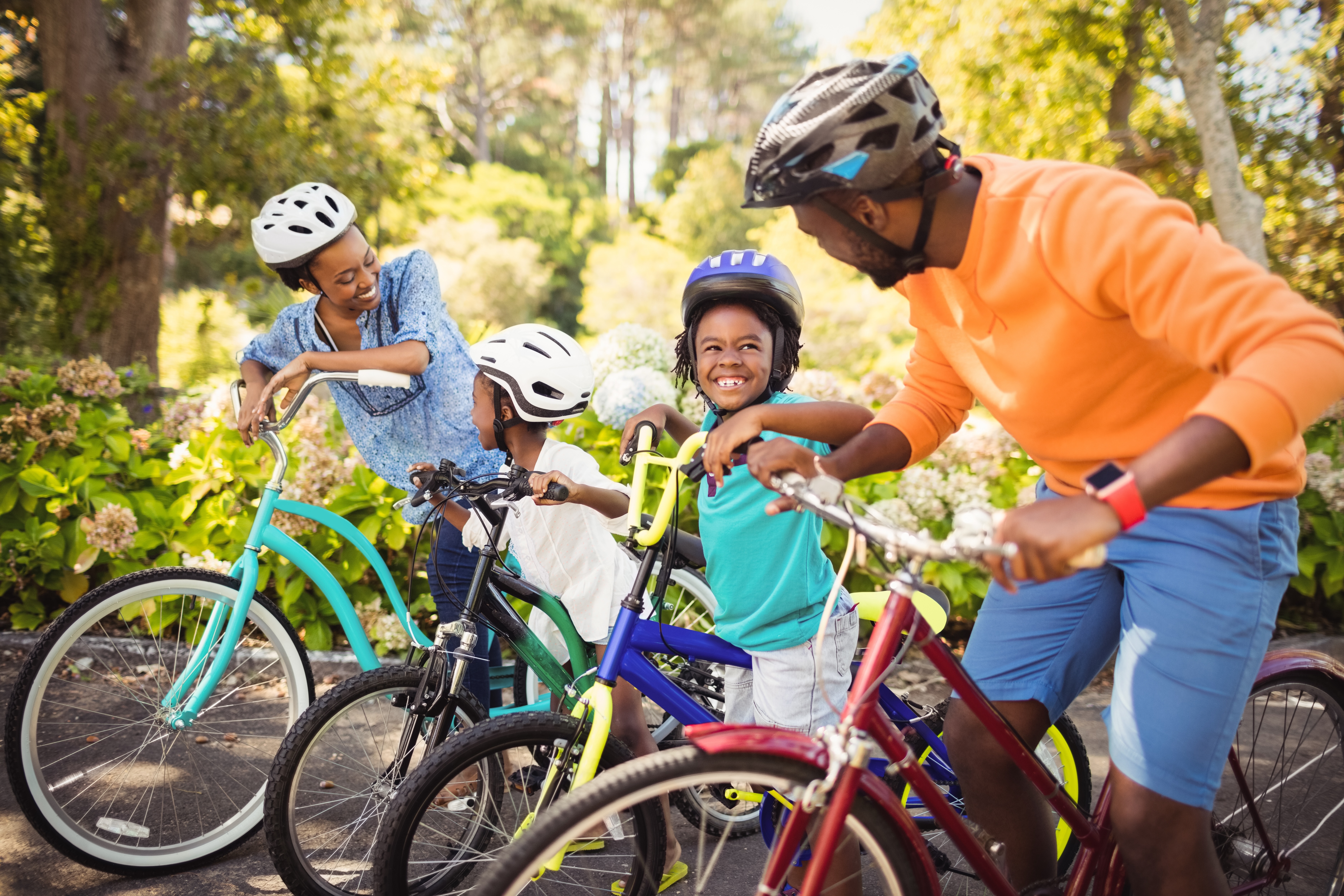 A family bikes on a greenway together