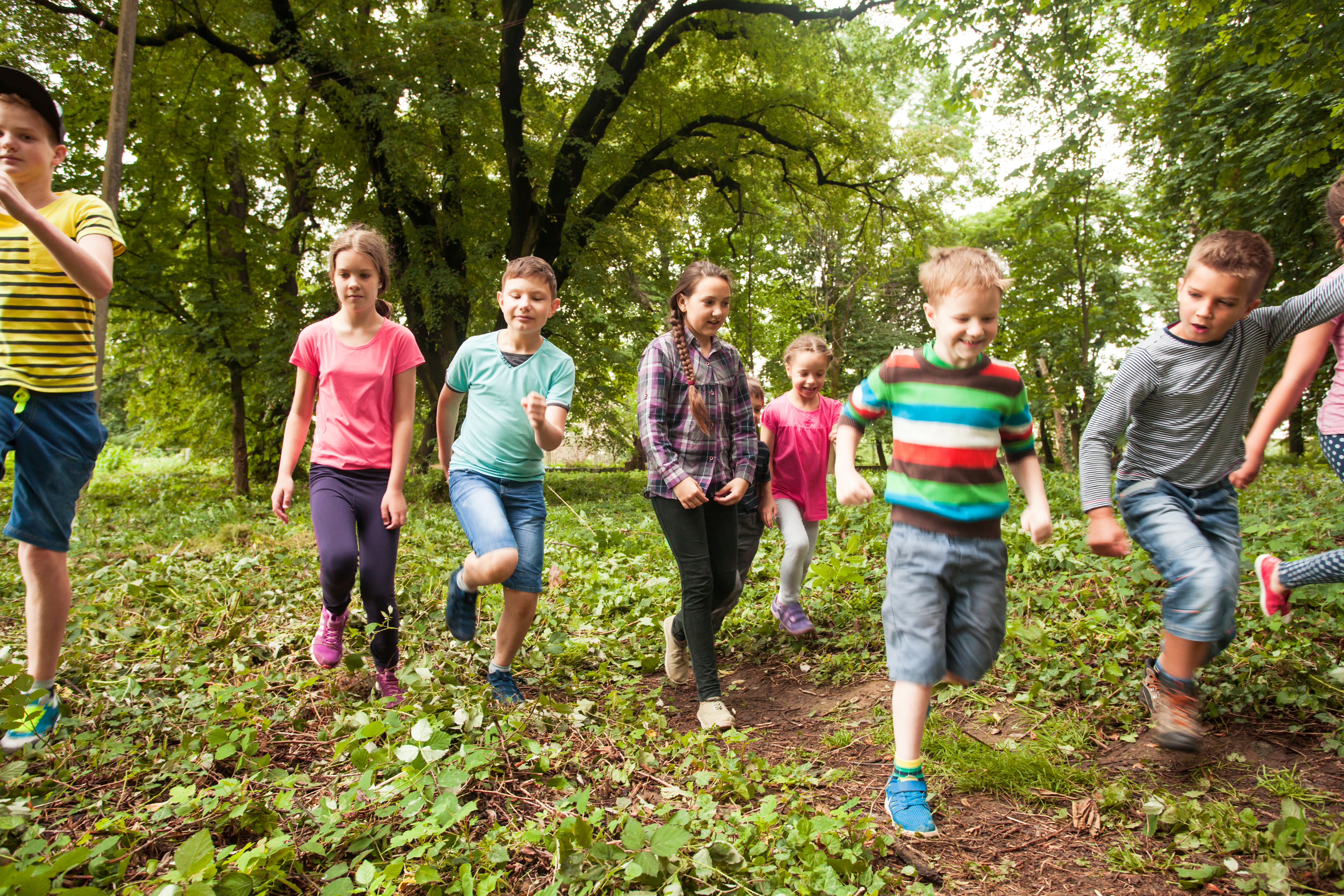 many children running together outside