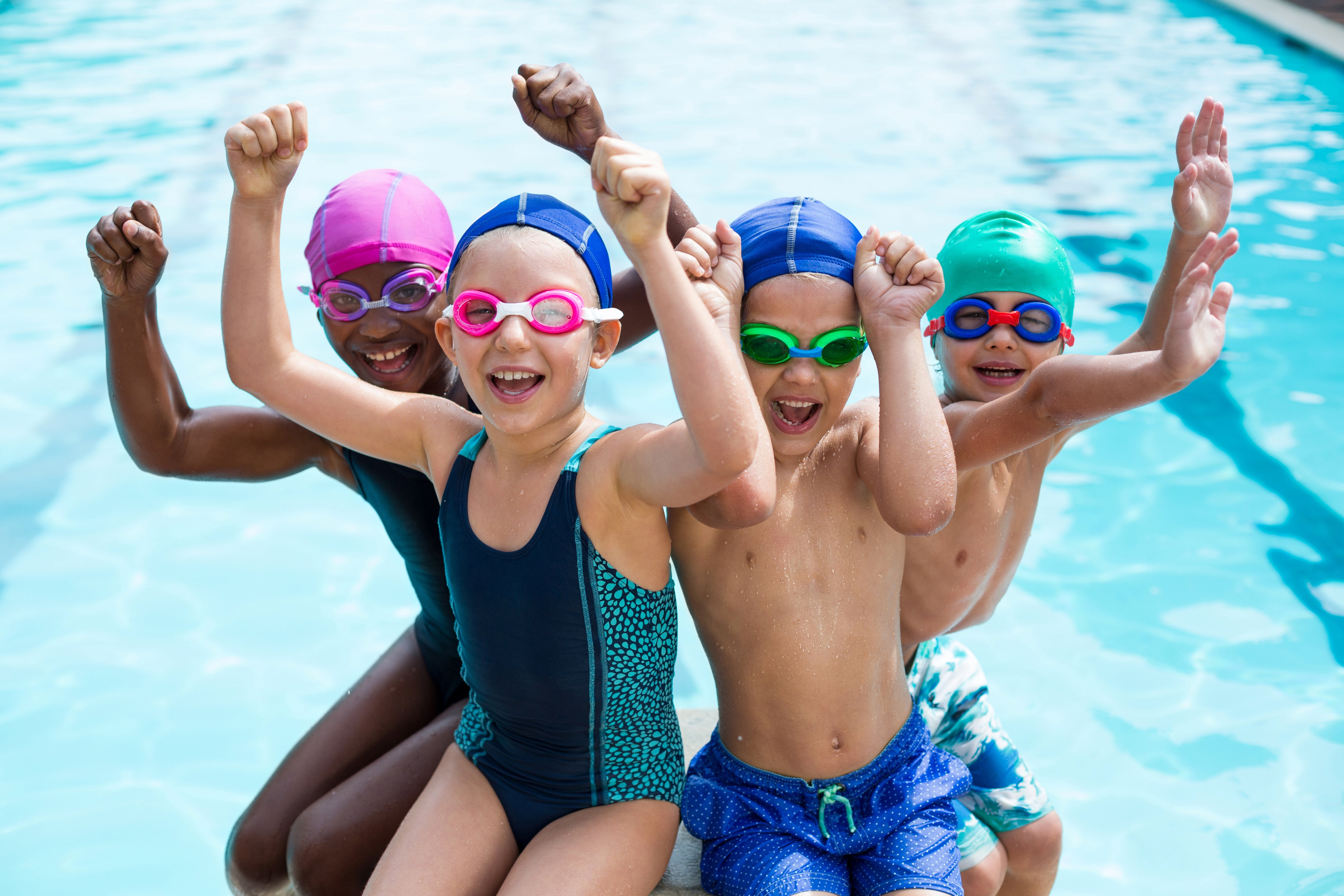 Kids sitting by swimming pool