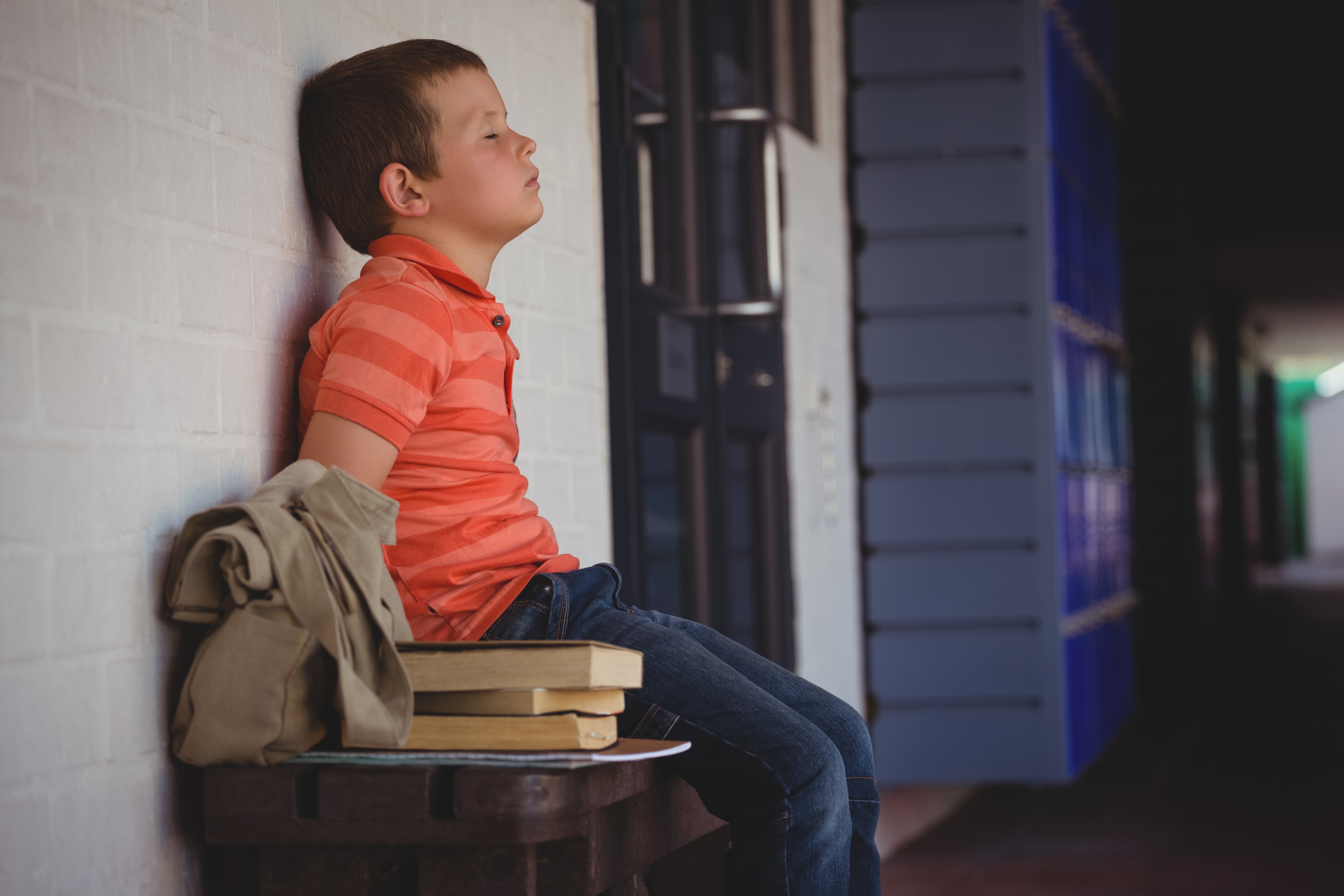 boy sitting with his eyes closed