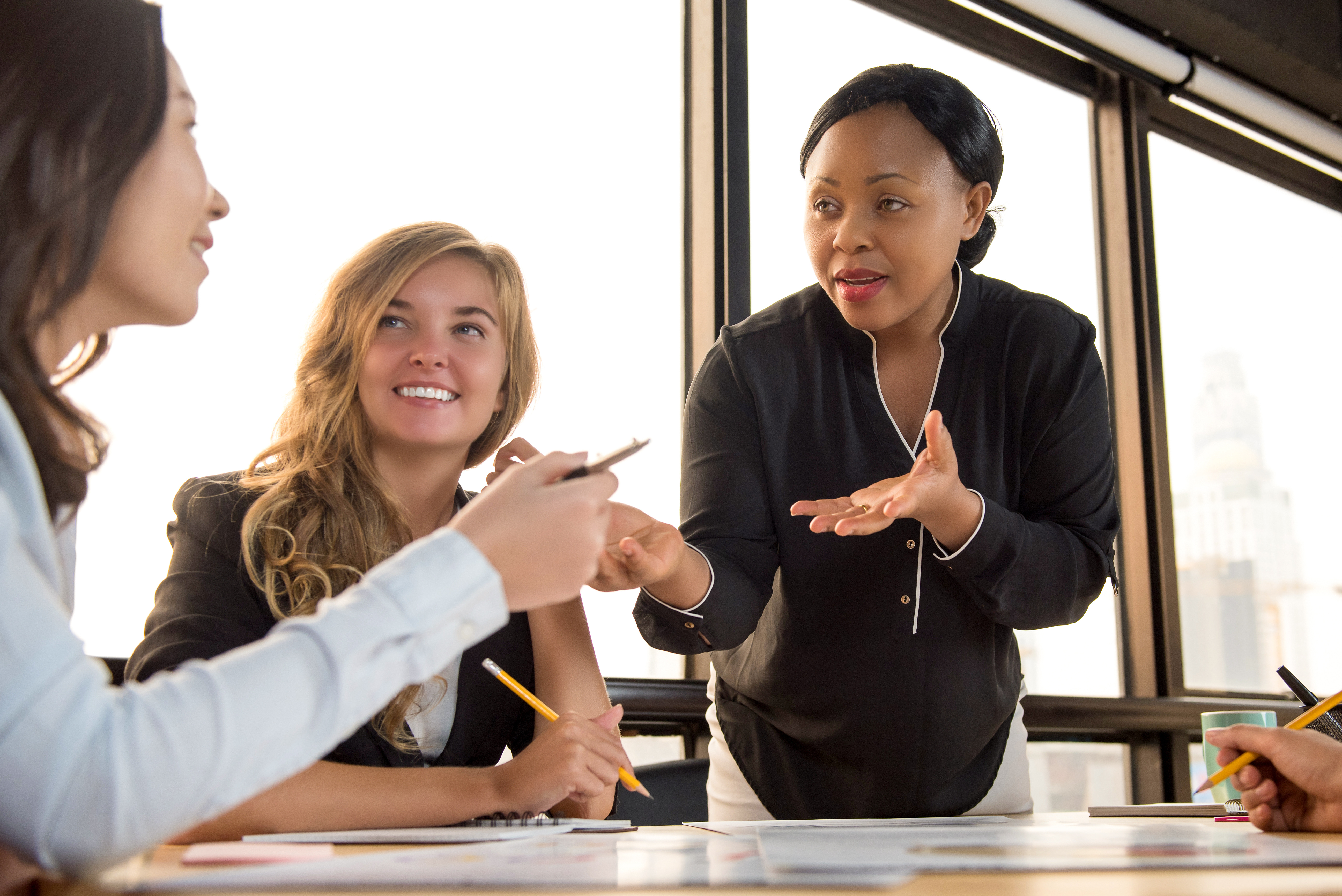 Three people work together, looking at one another