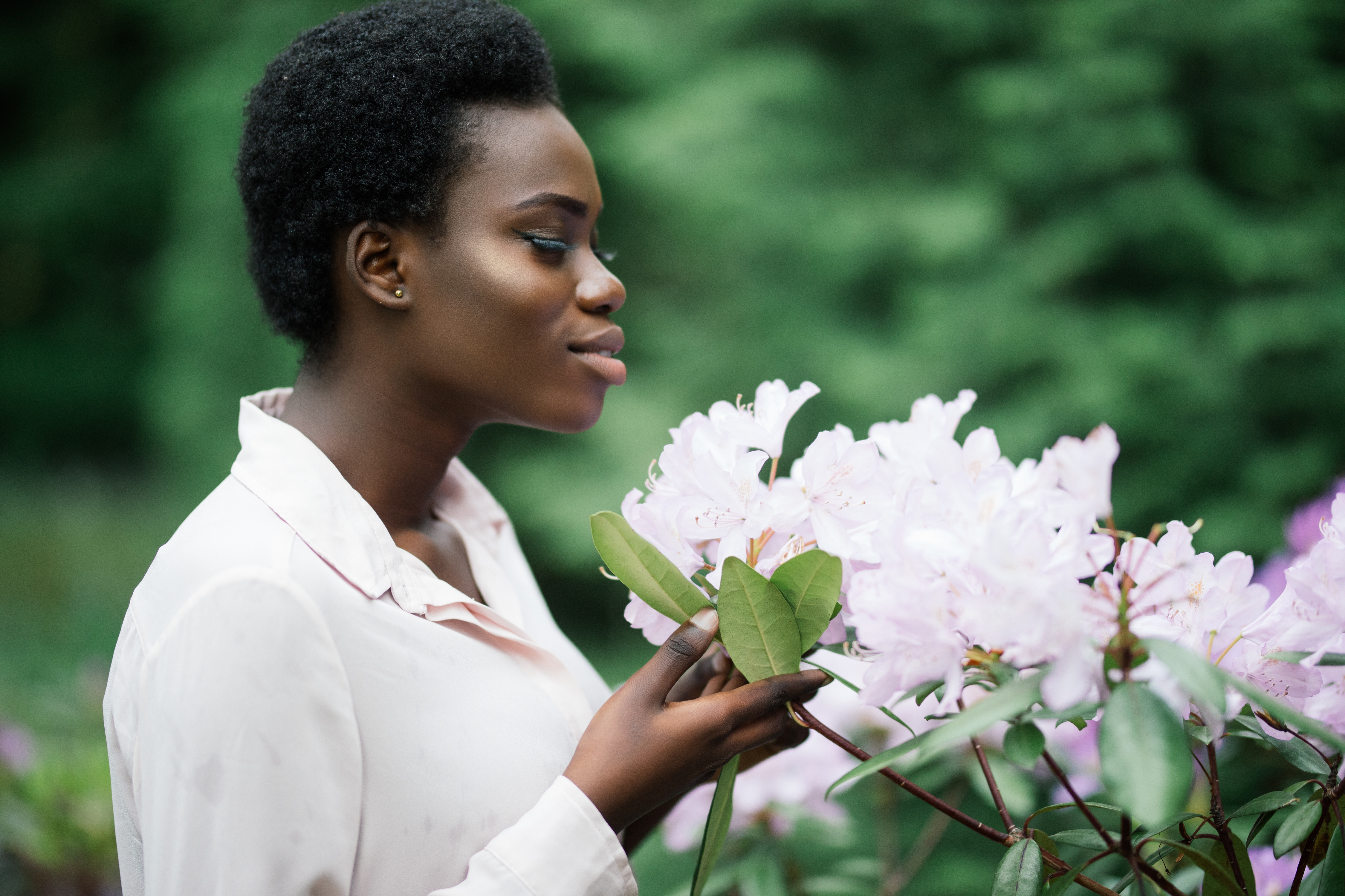 woman examining a flower