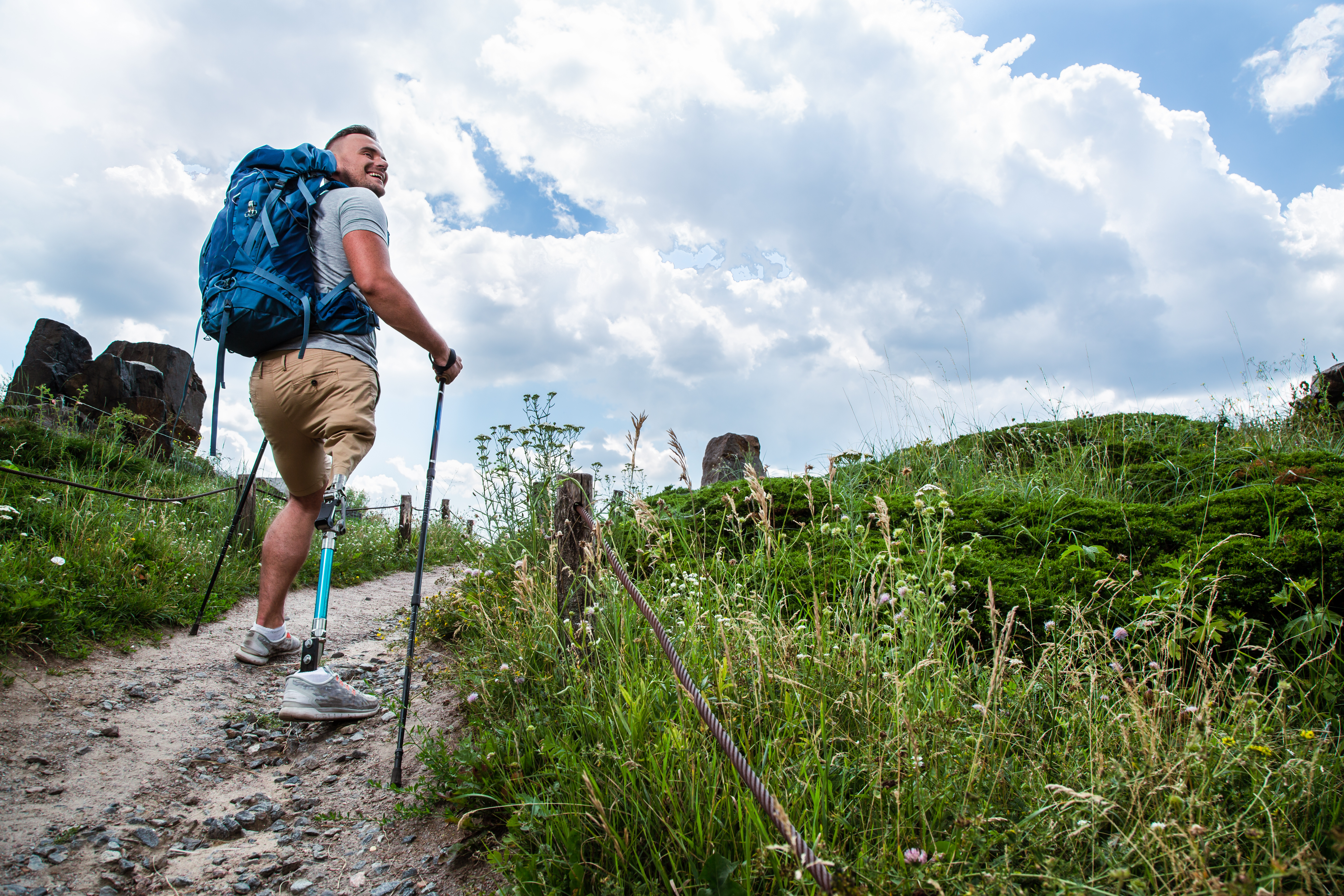 A person walks up a rocky trail