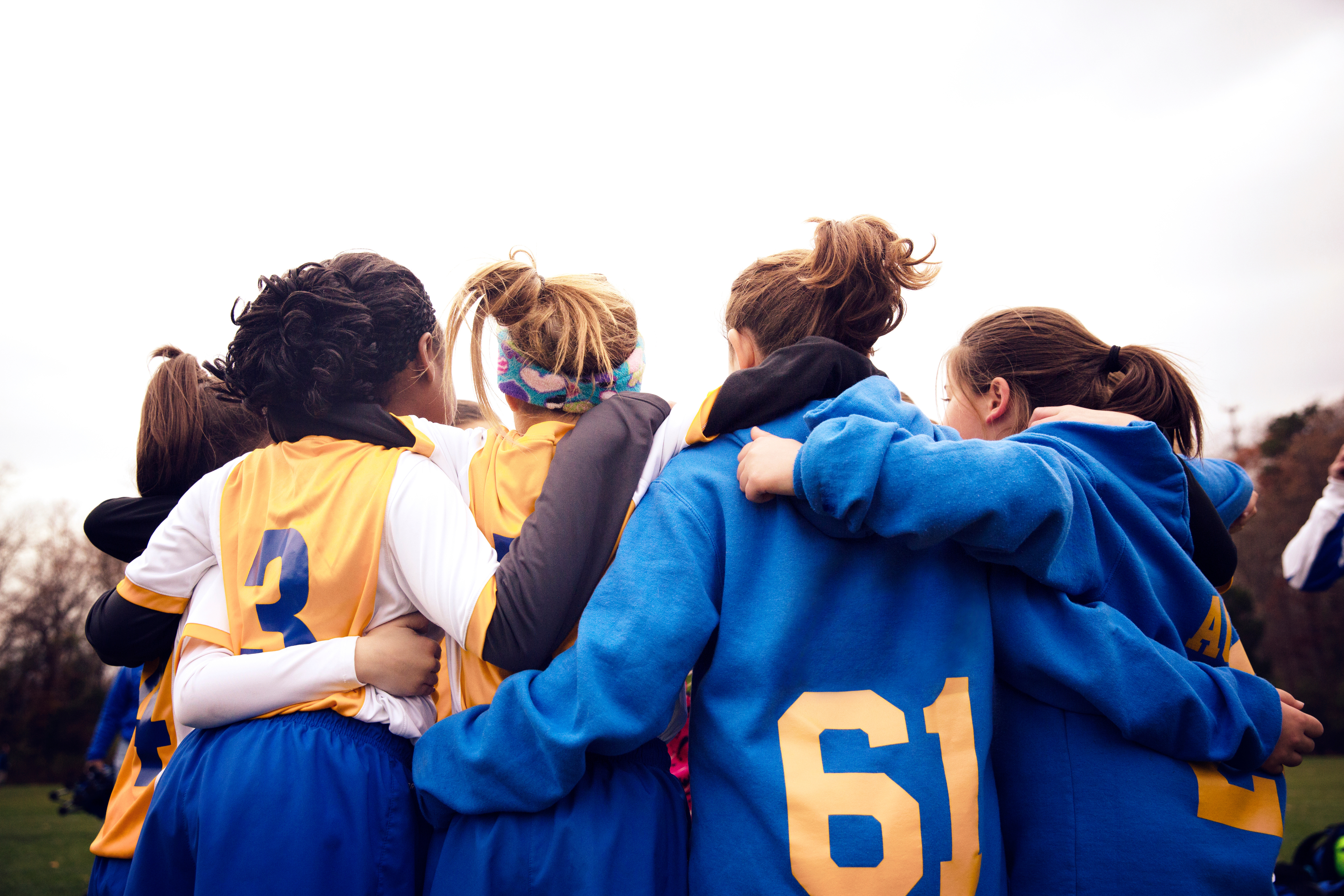 A sports team huddles together