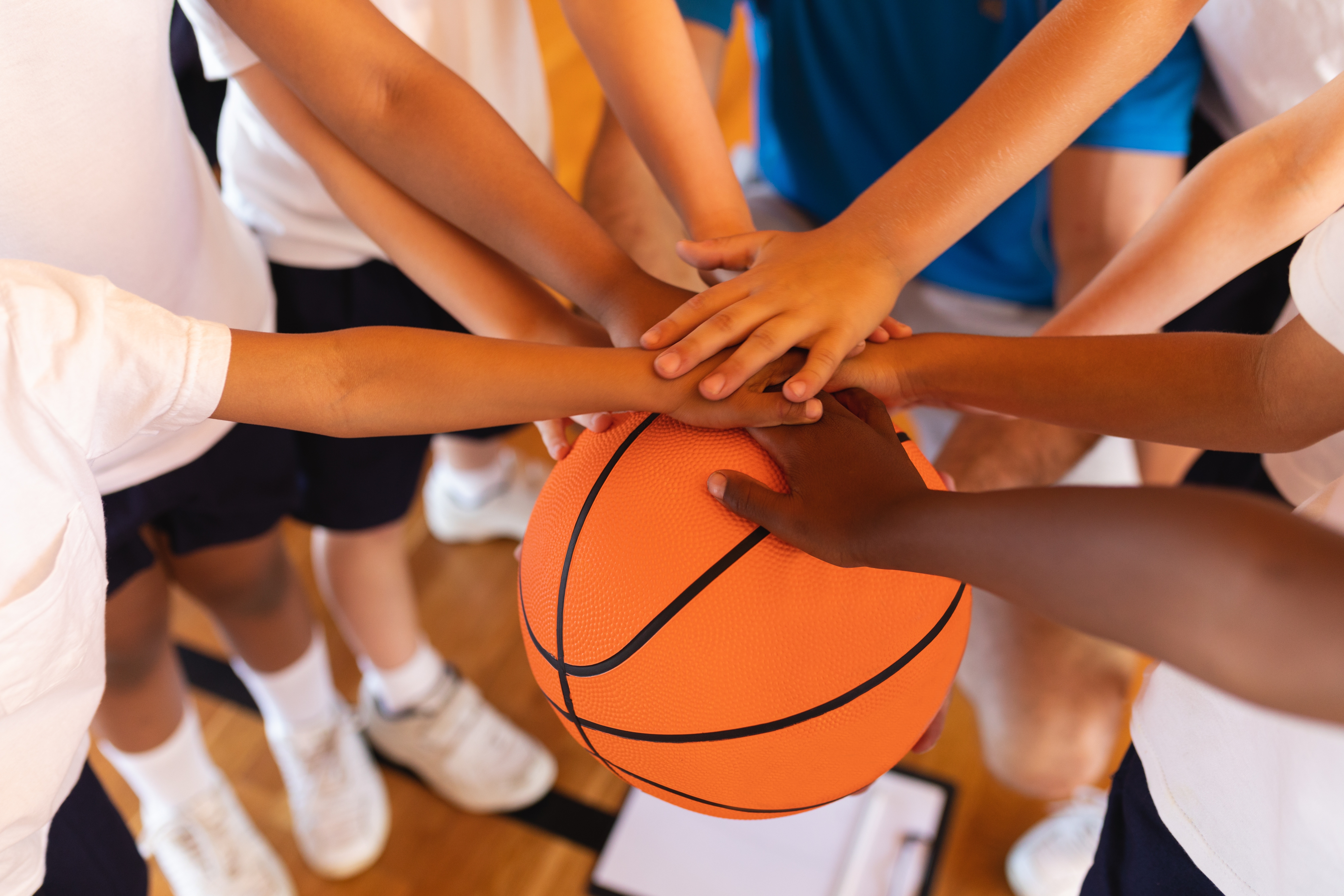 Group of hands on a basketball