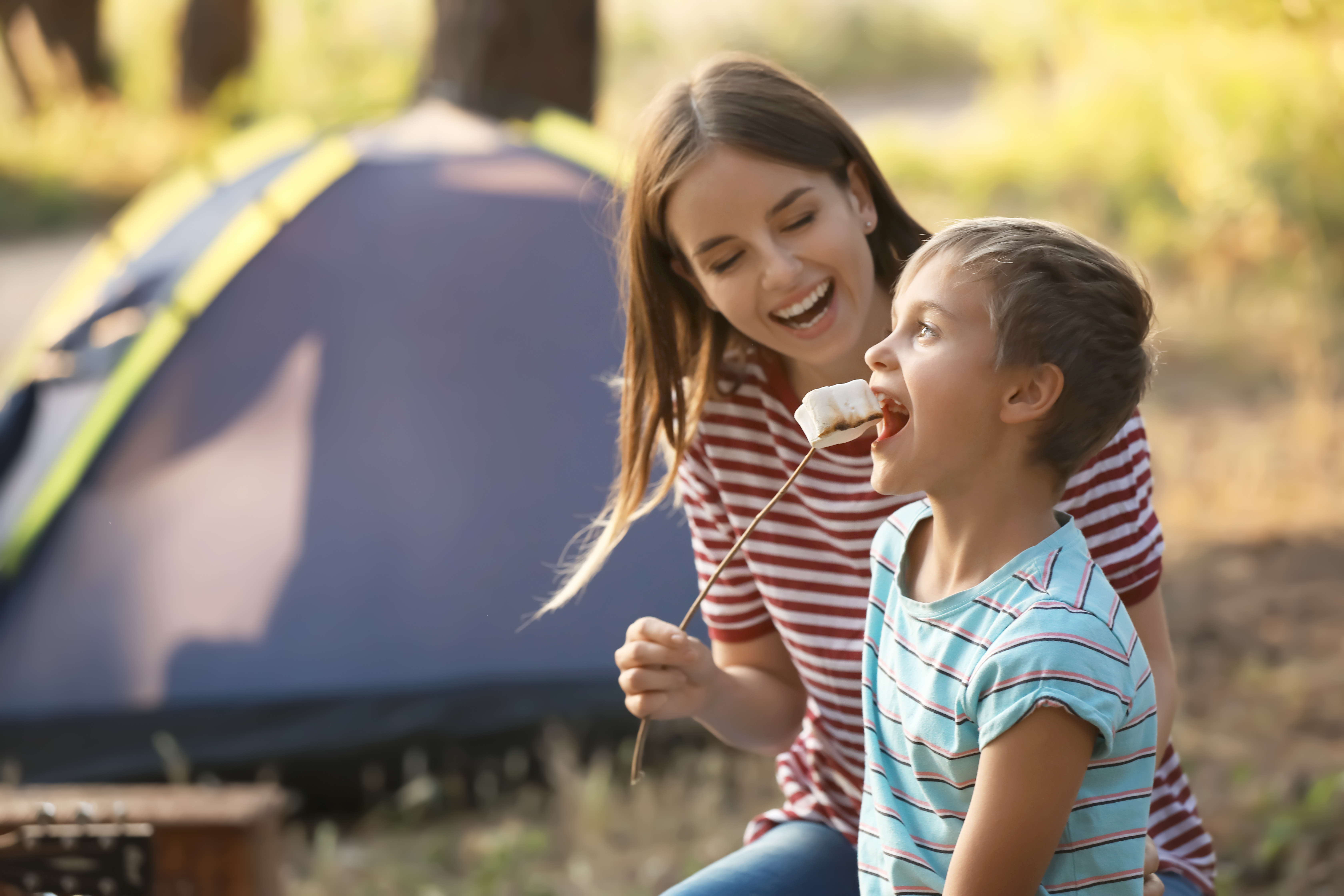 kids eating marshmallows at a campfire