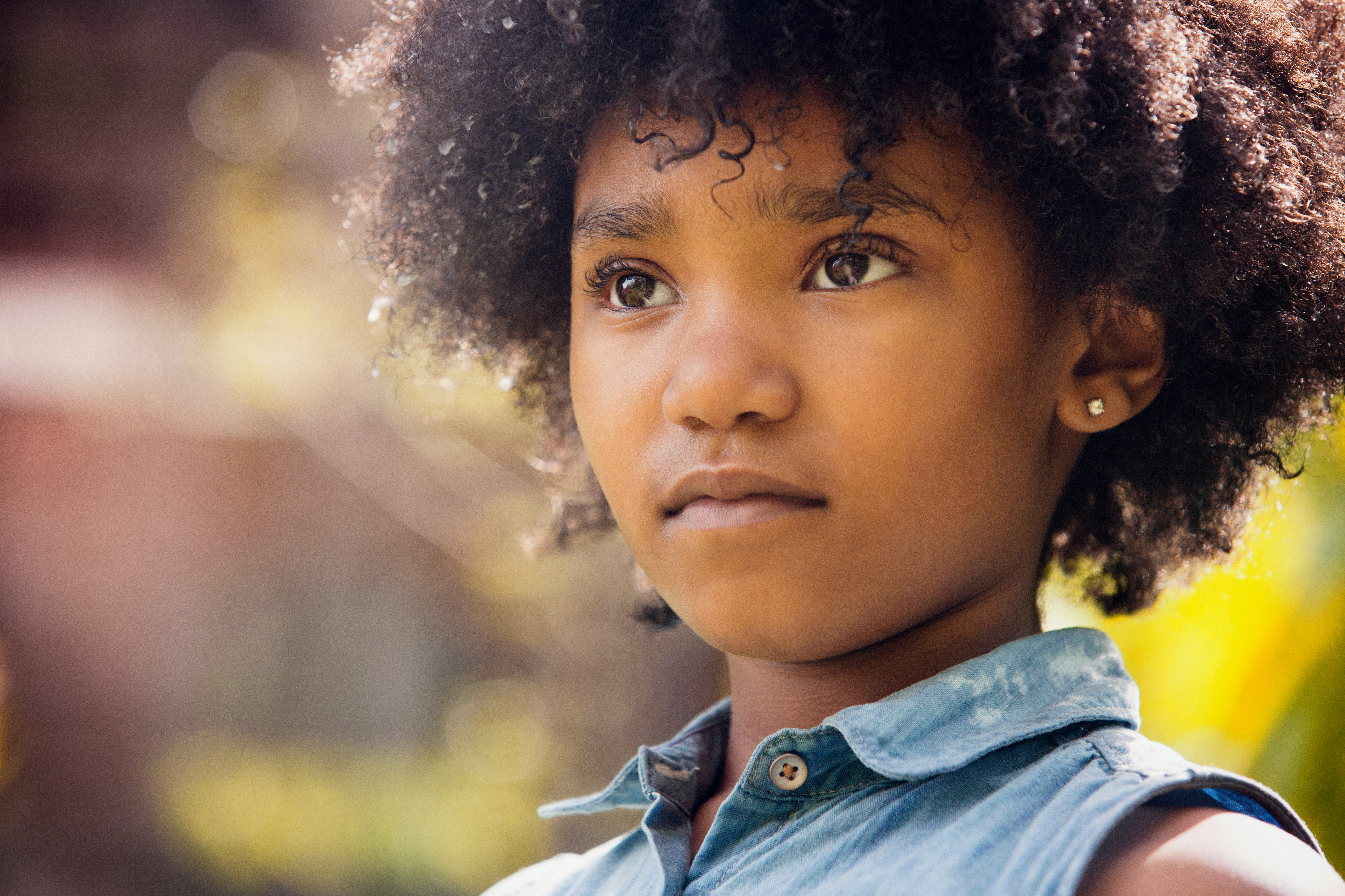 A young person stares just past the camera