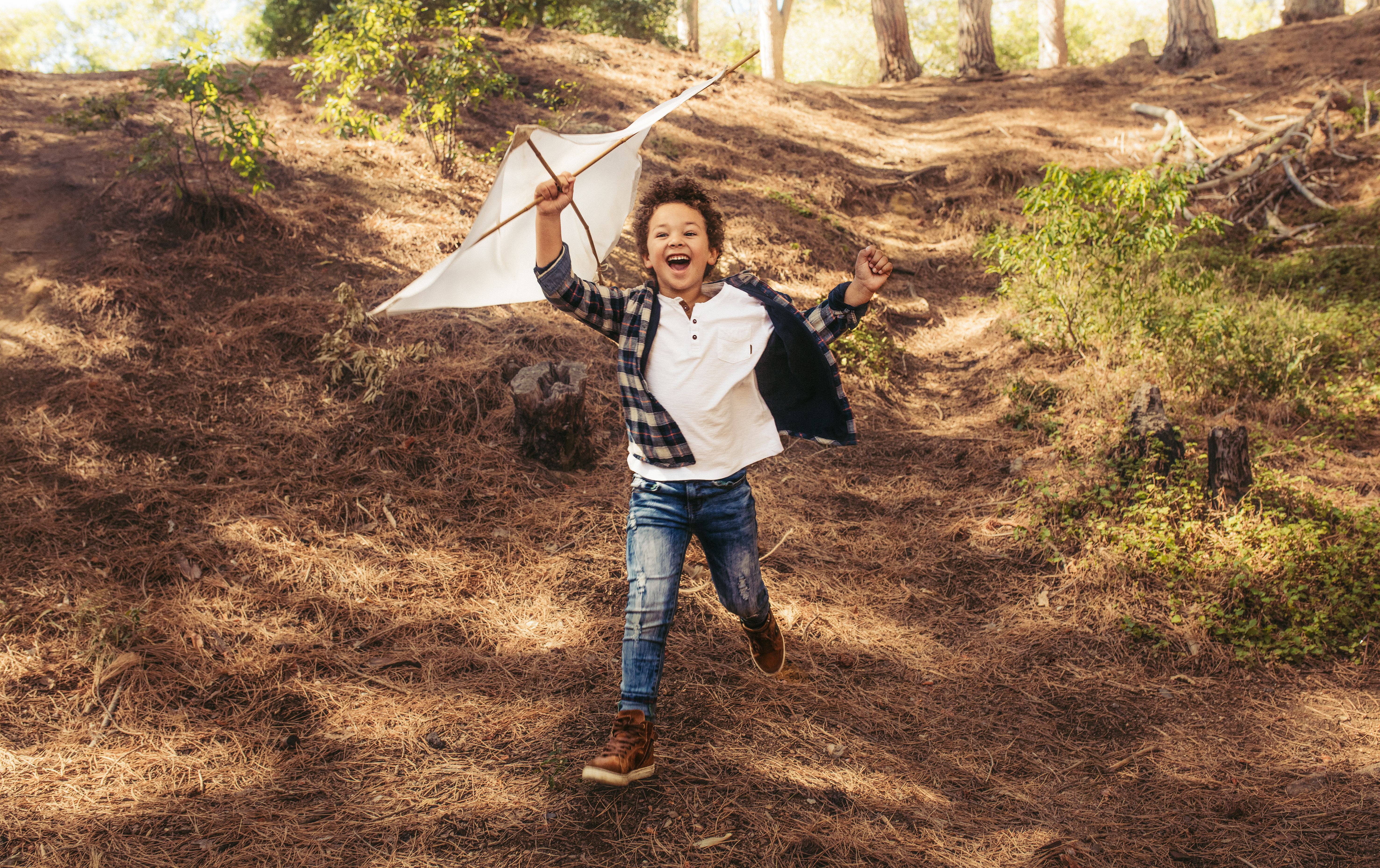 boy running with kite