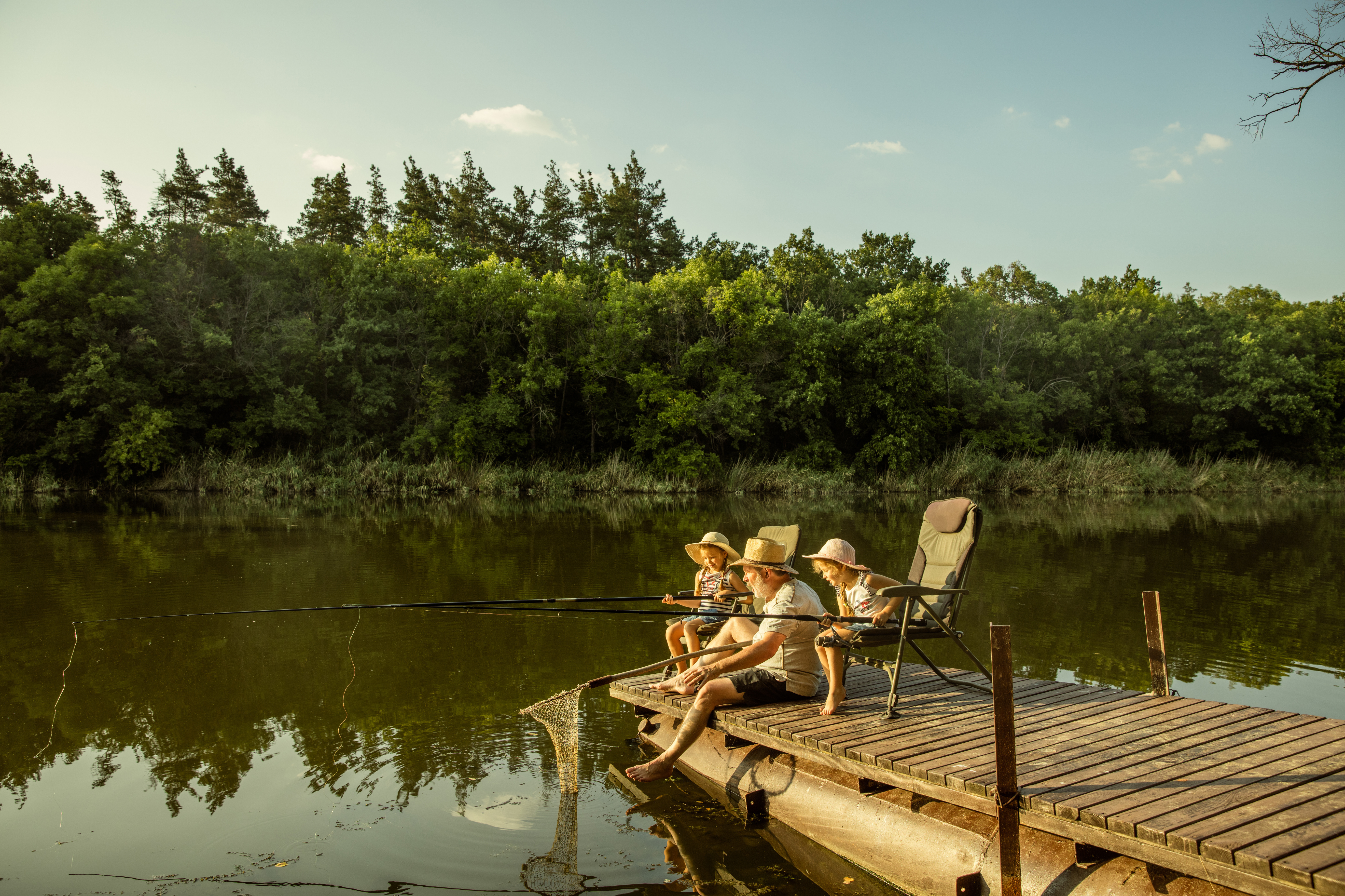 family fishing off a dock