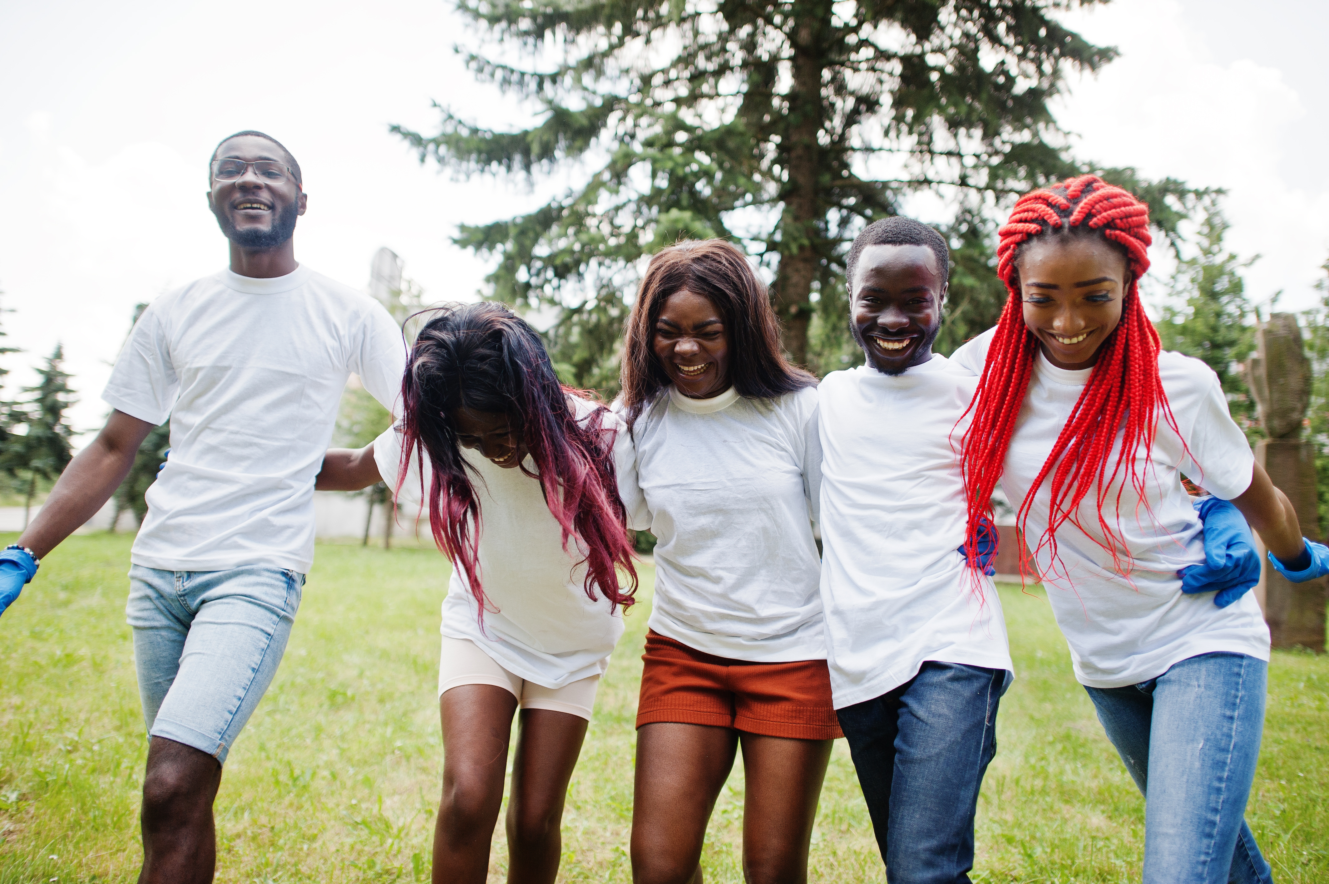 A group of youth walk together and laugh during a service project