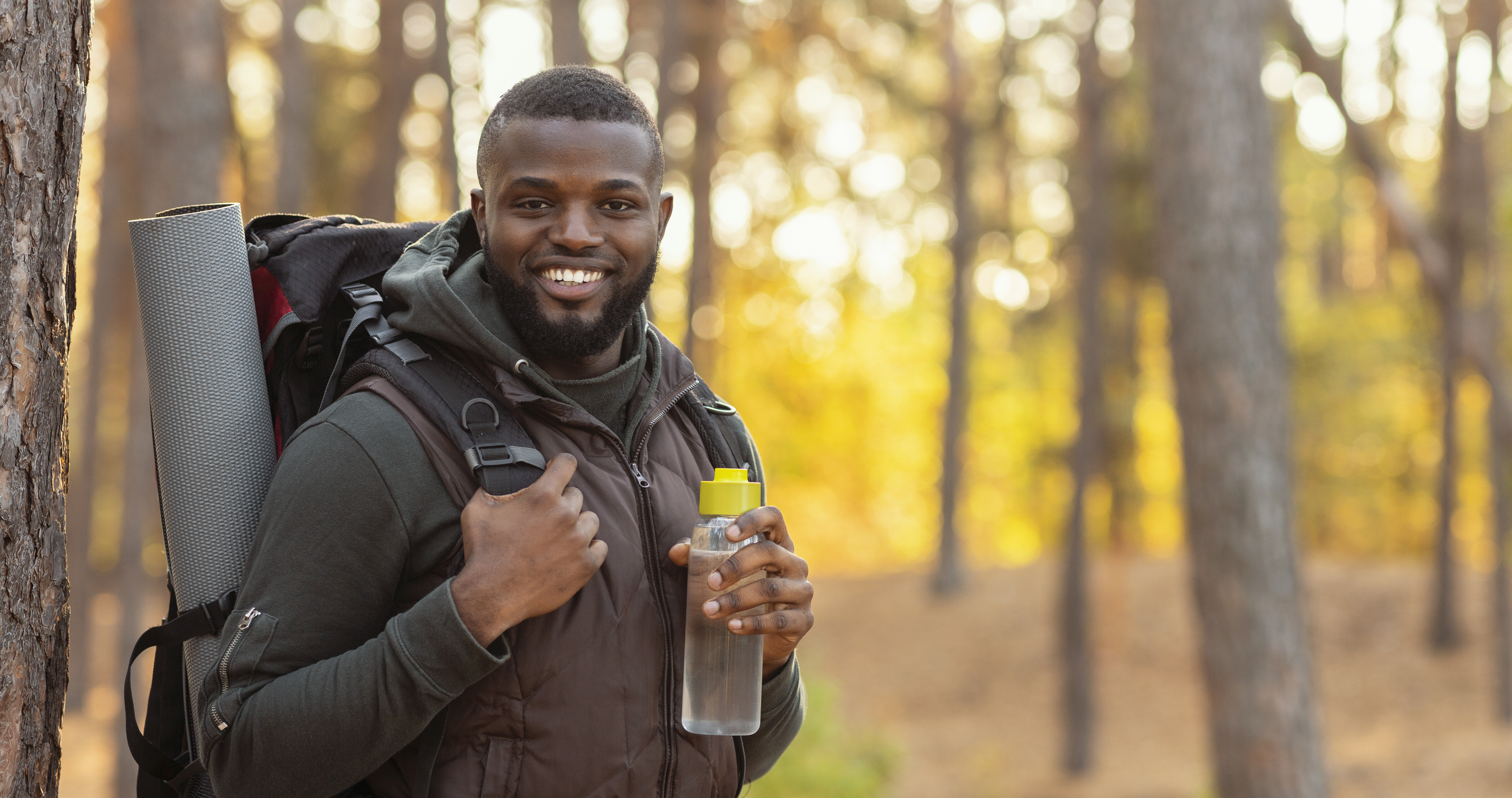 man in the woods with a backpack