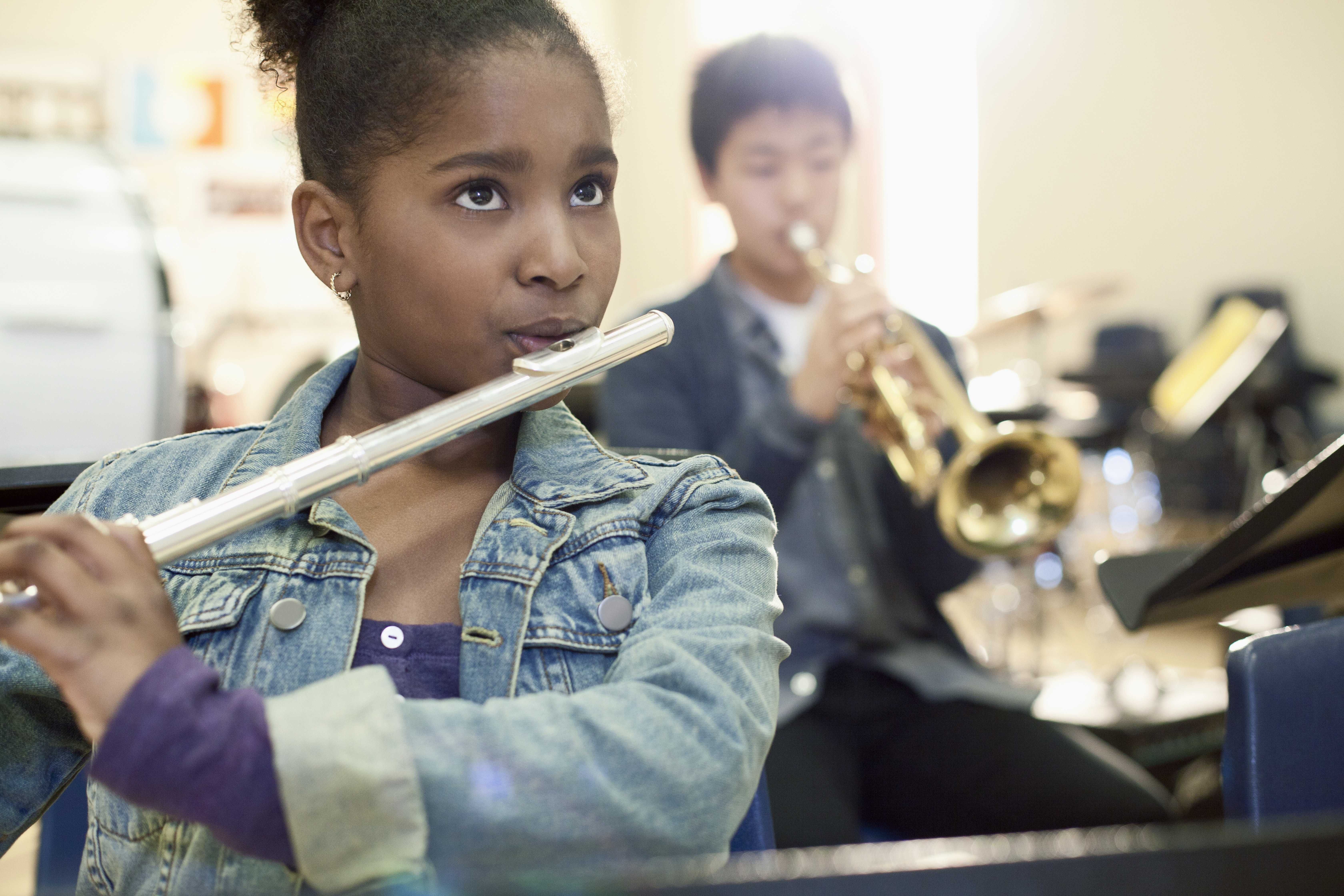 girl playing a flute in school