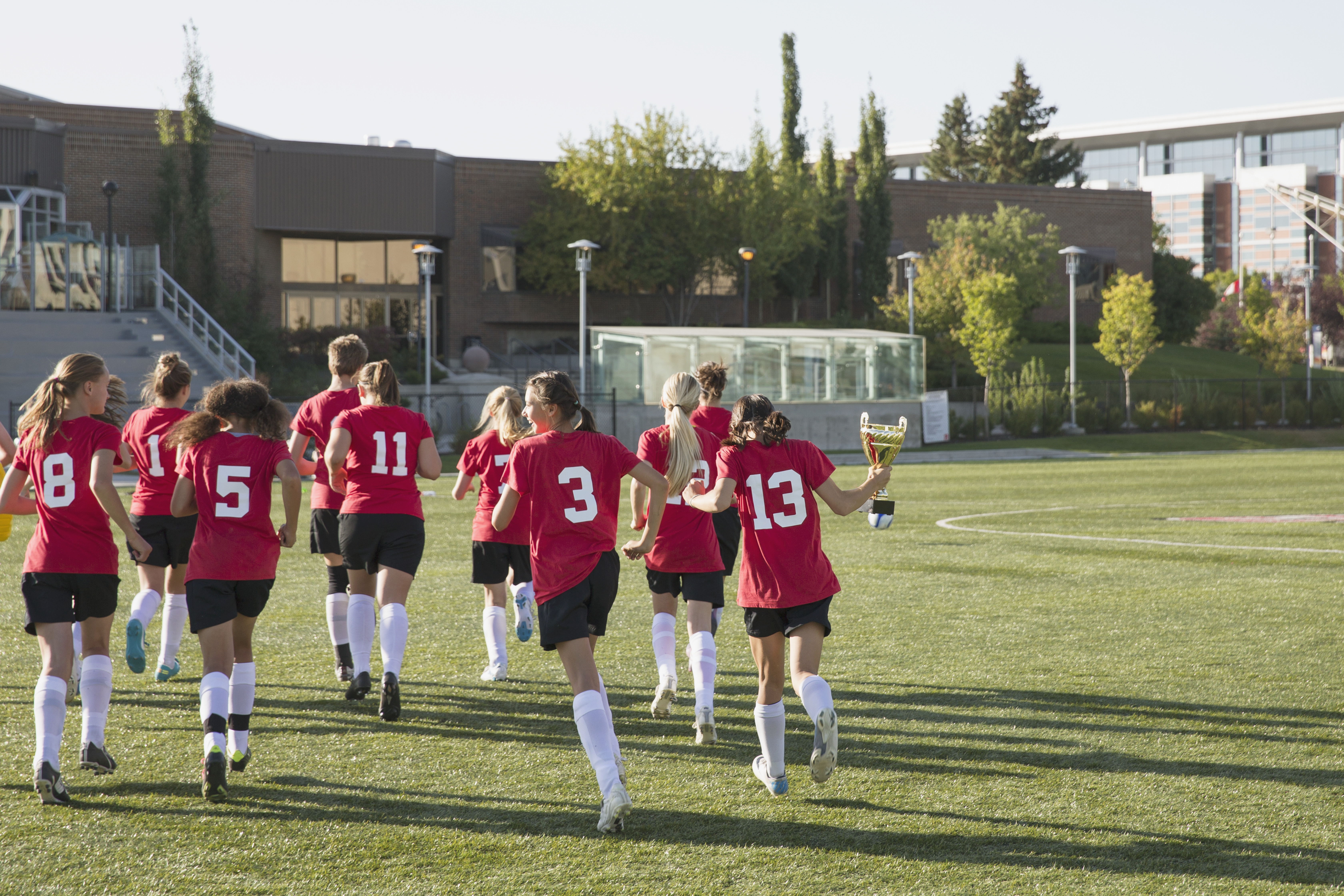 A women's soccer team runs off the field