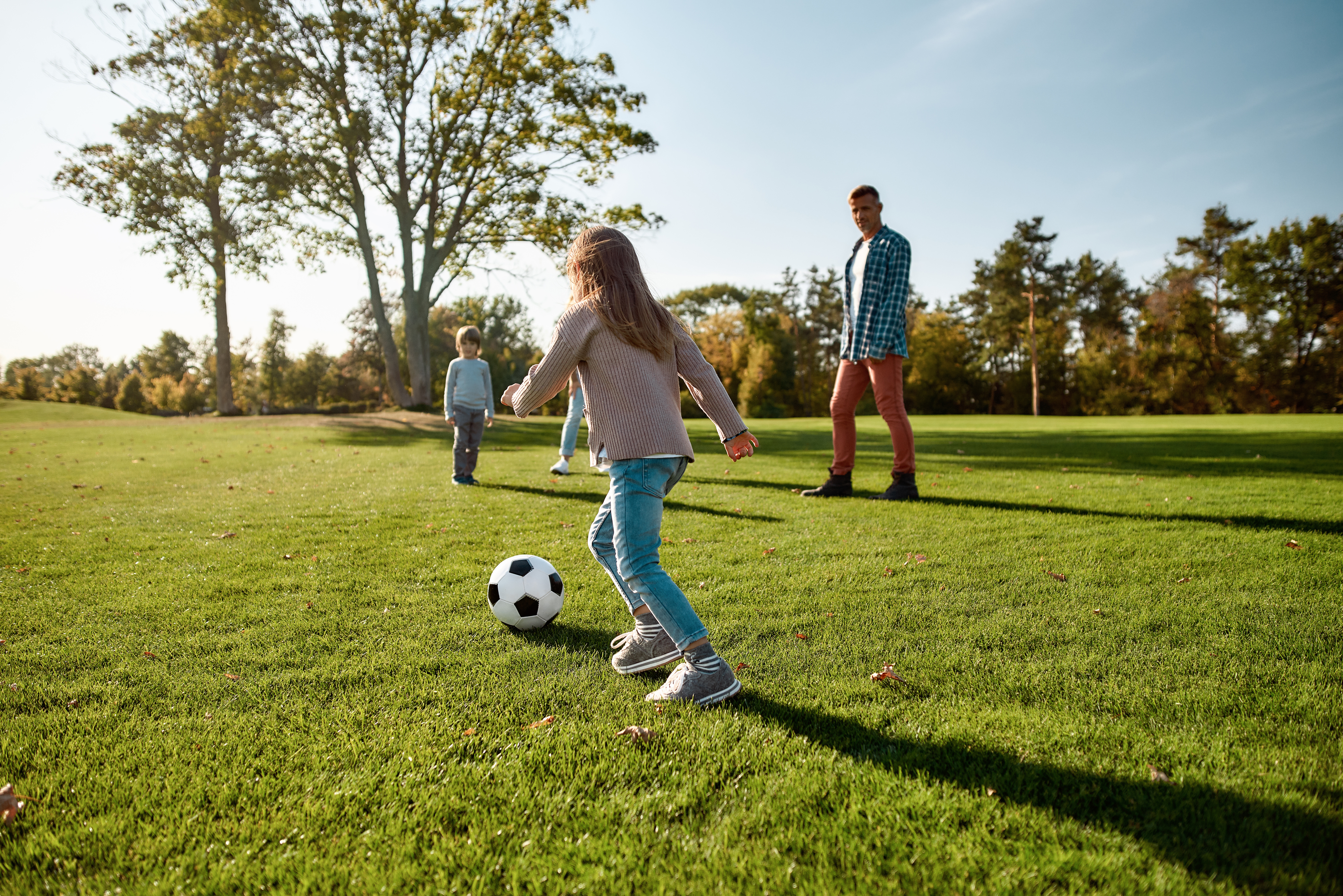 kids play soccer in a park