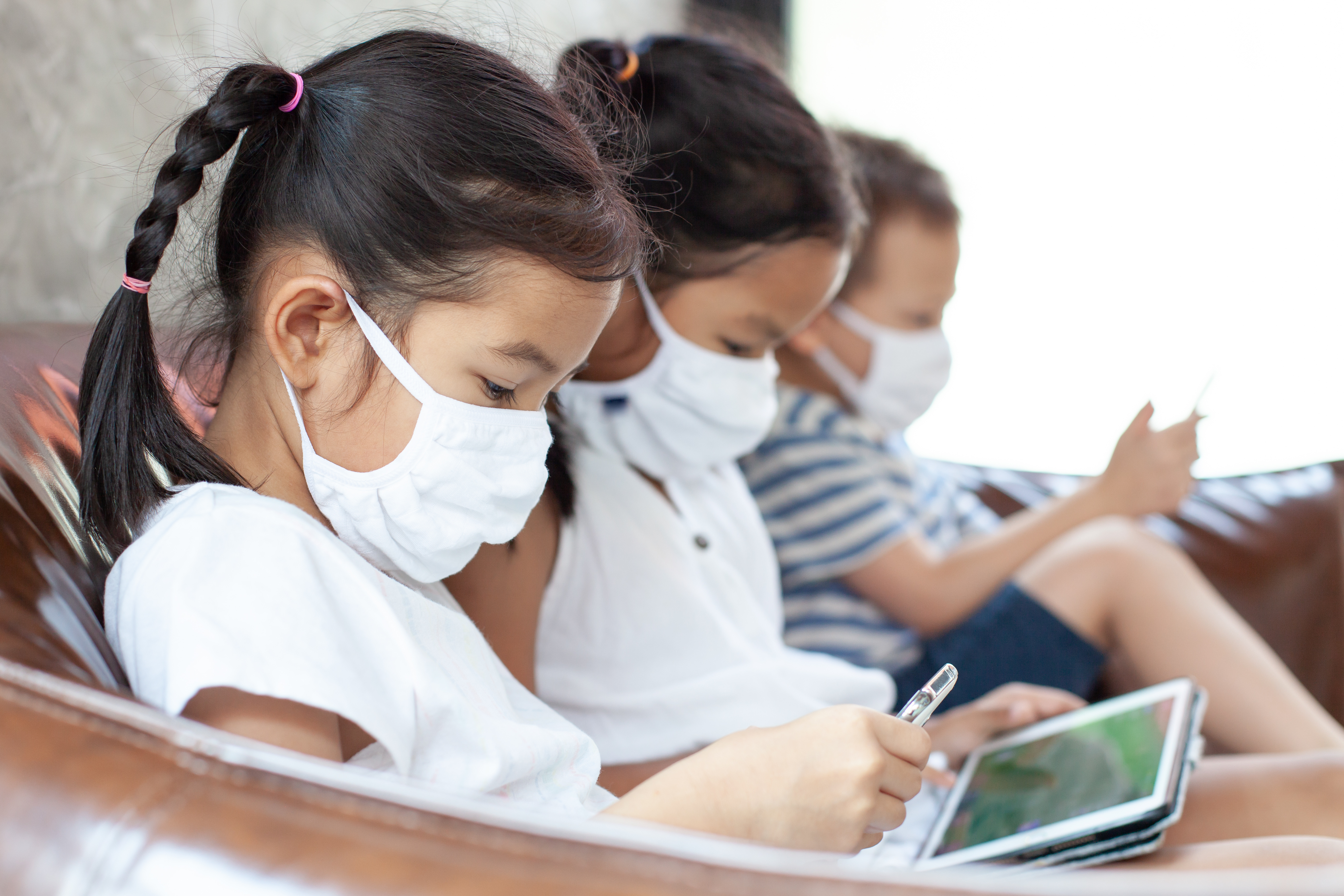 kids watch screens while wearing masks