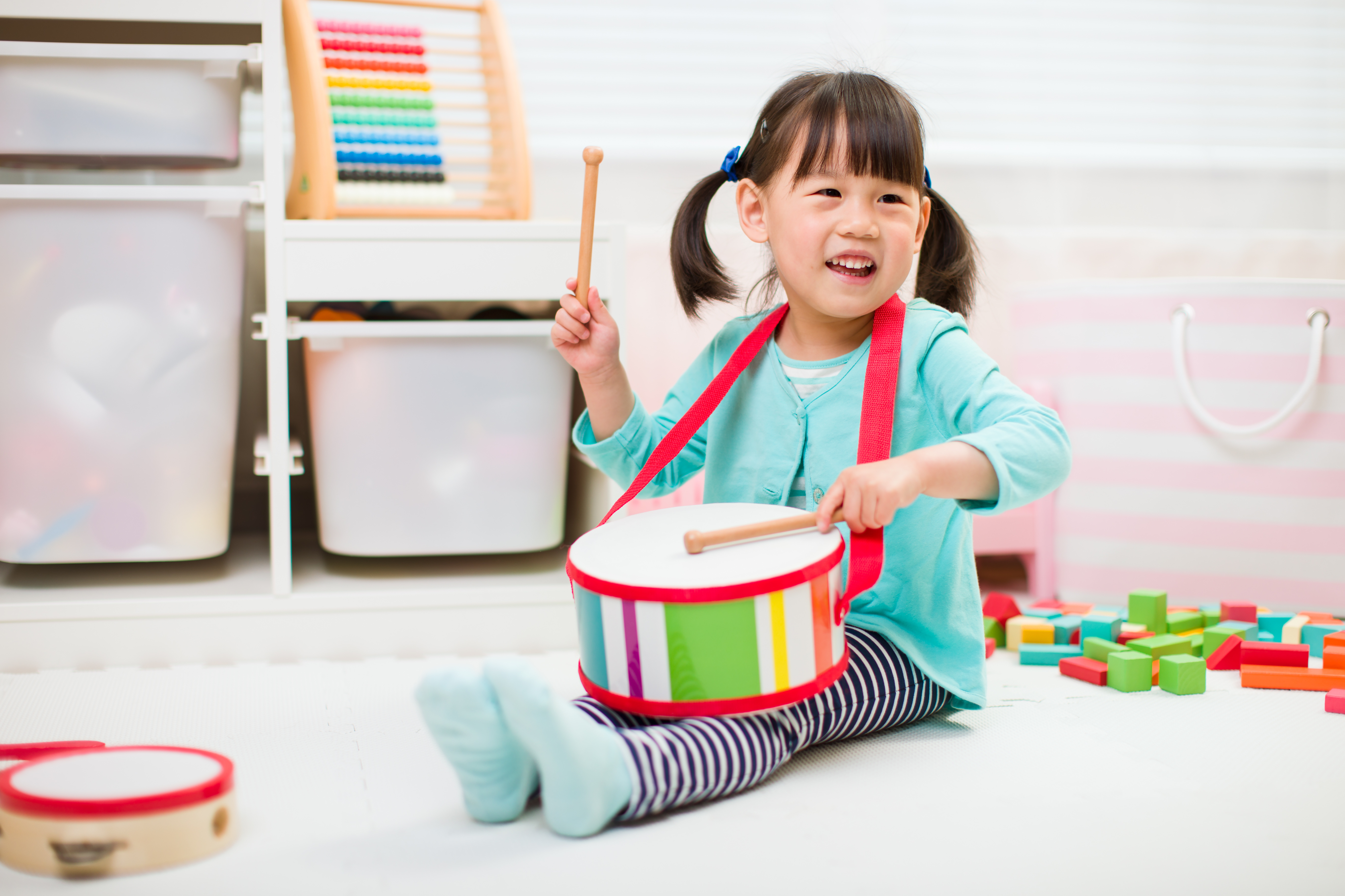 little girl playing a drum