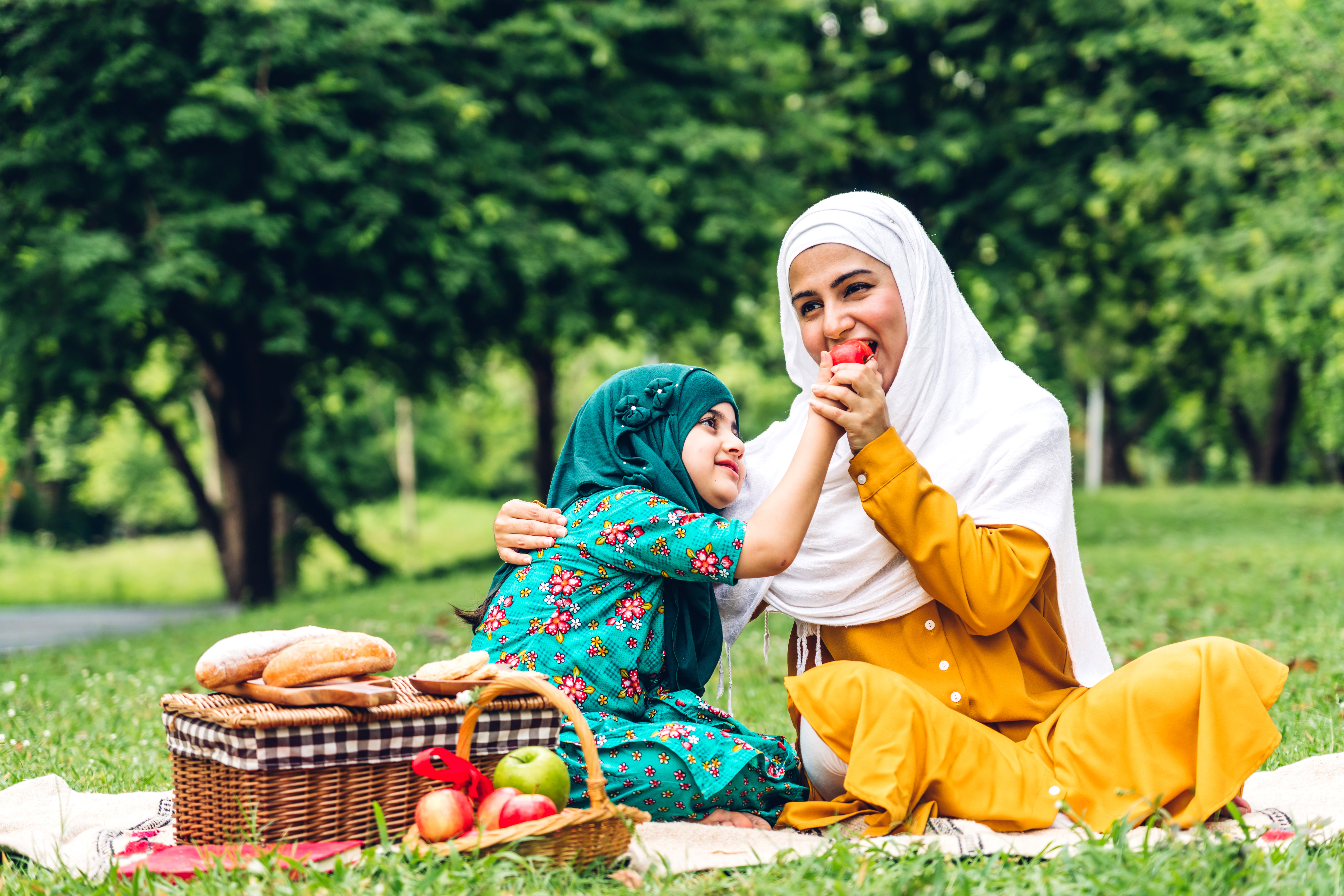 a mother and daughter have a picnic