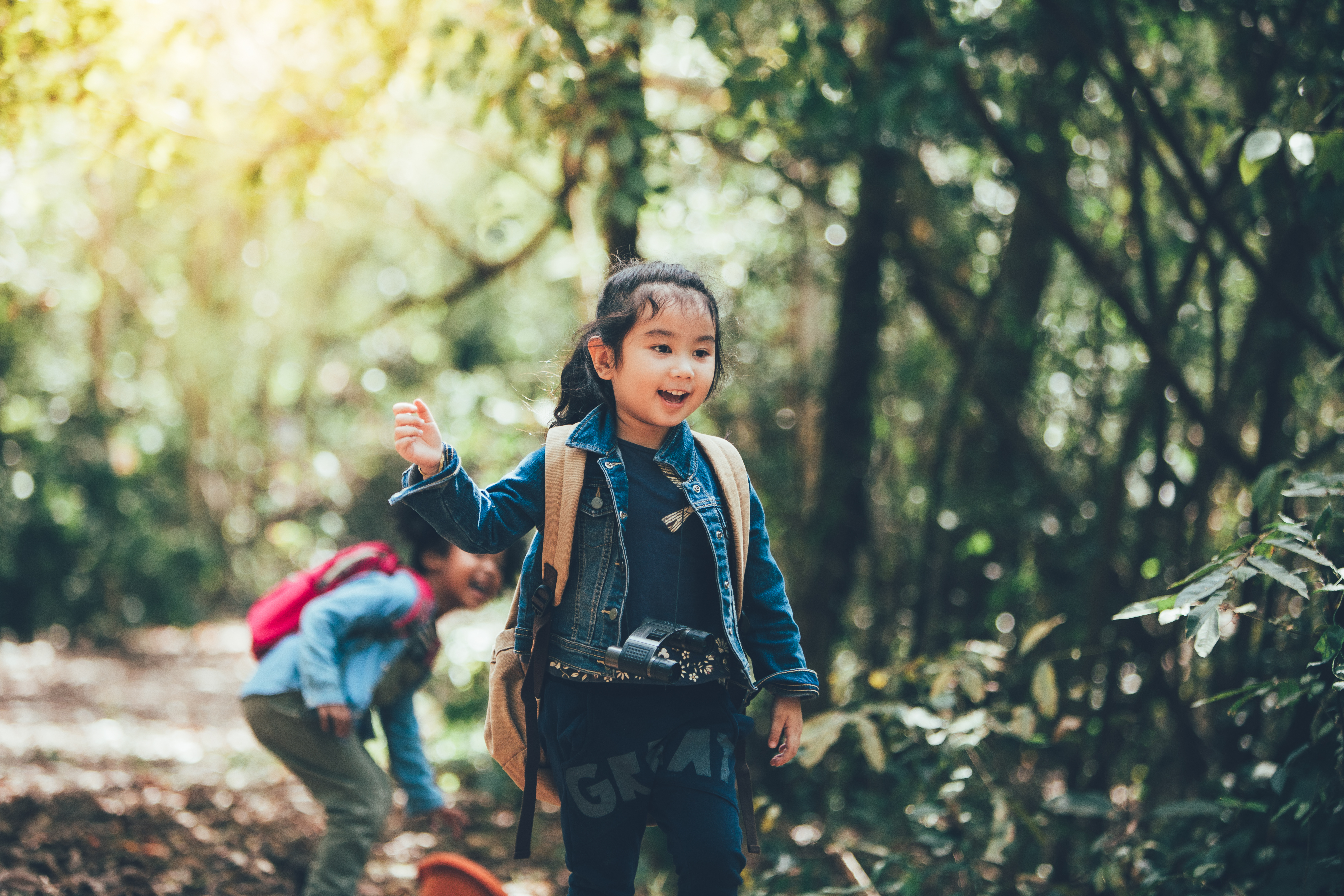 A child walks down a path, exploring nature. 