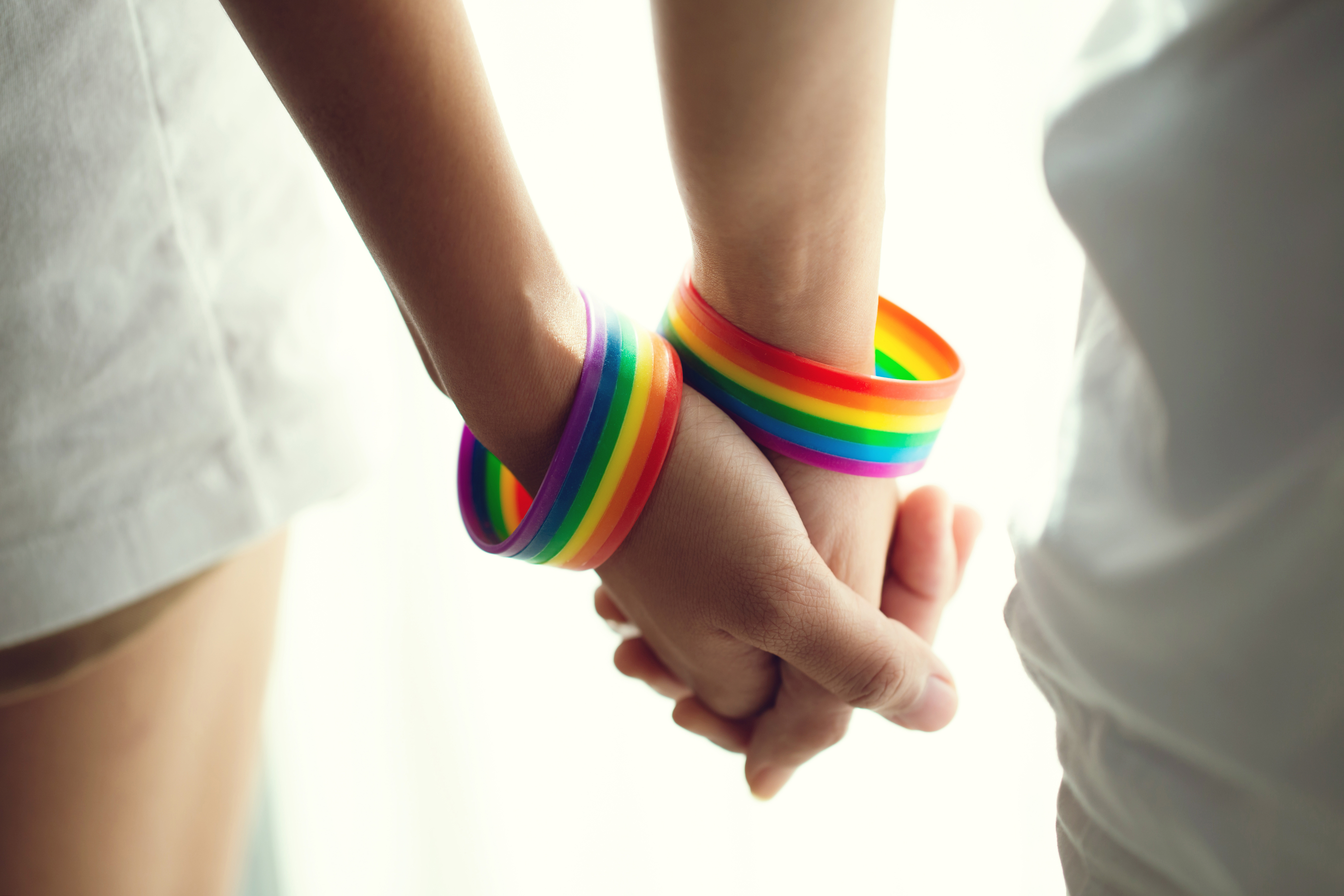 holding hands with rainbow bracelets