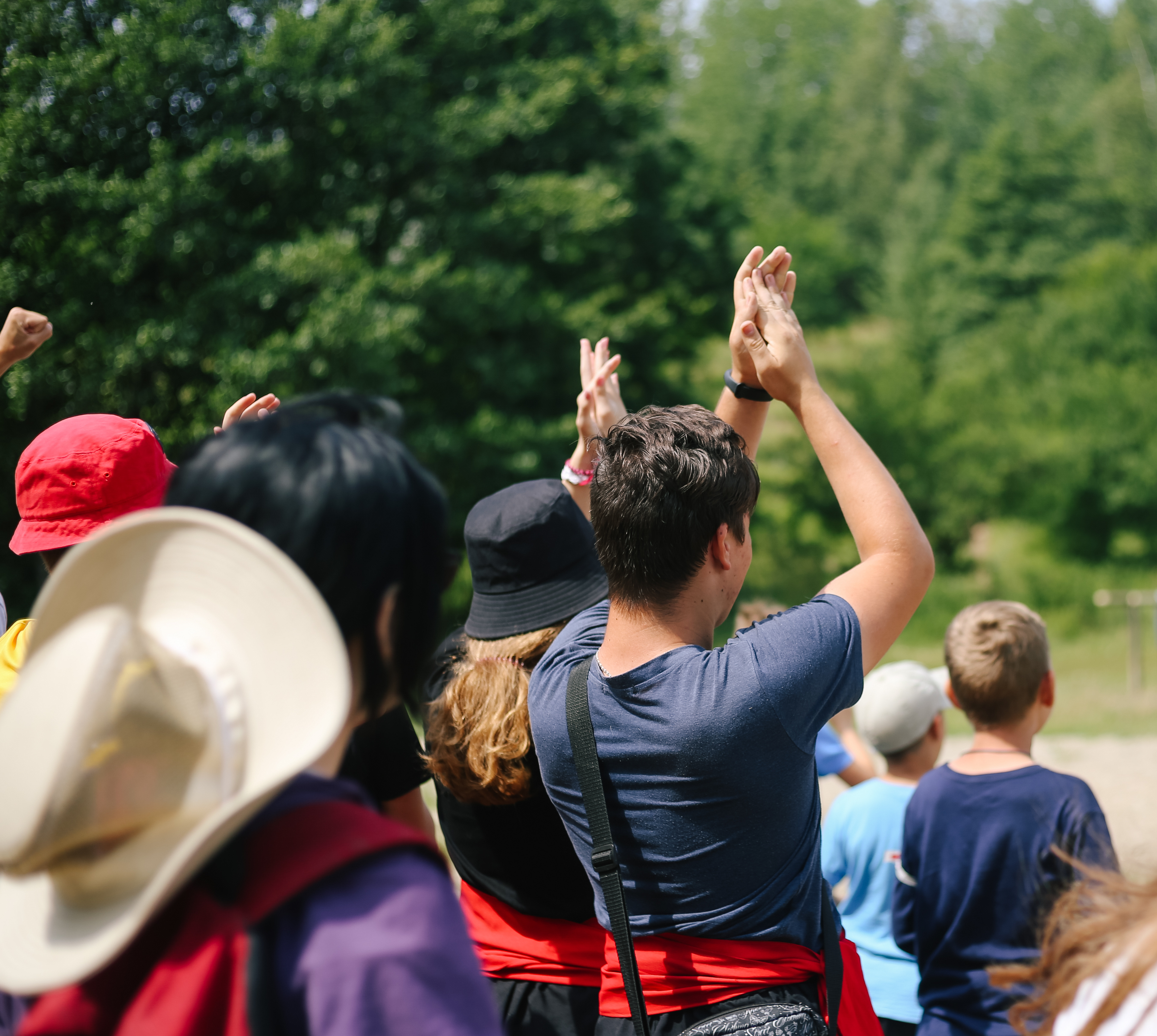 a counselor encourages campers as part of a group