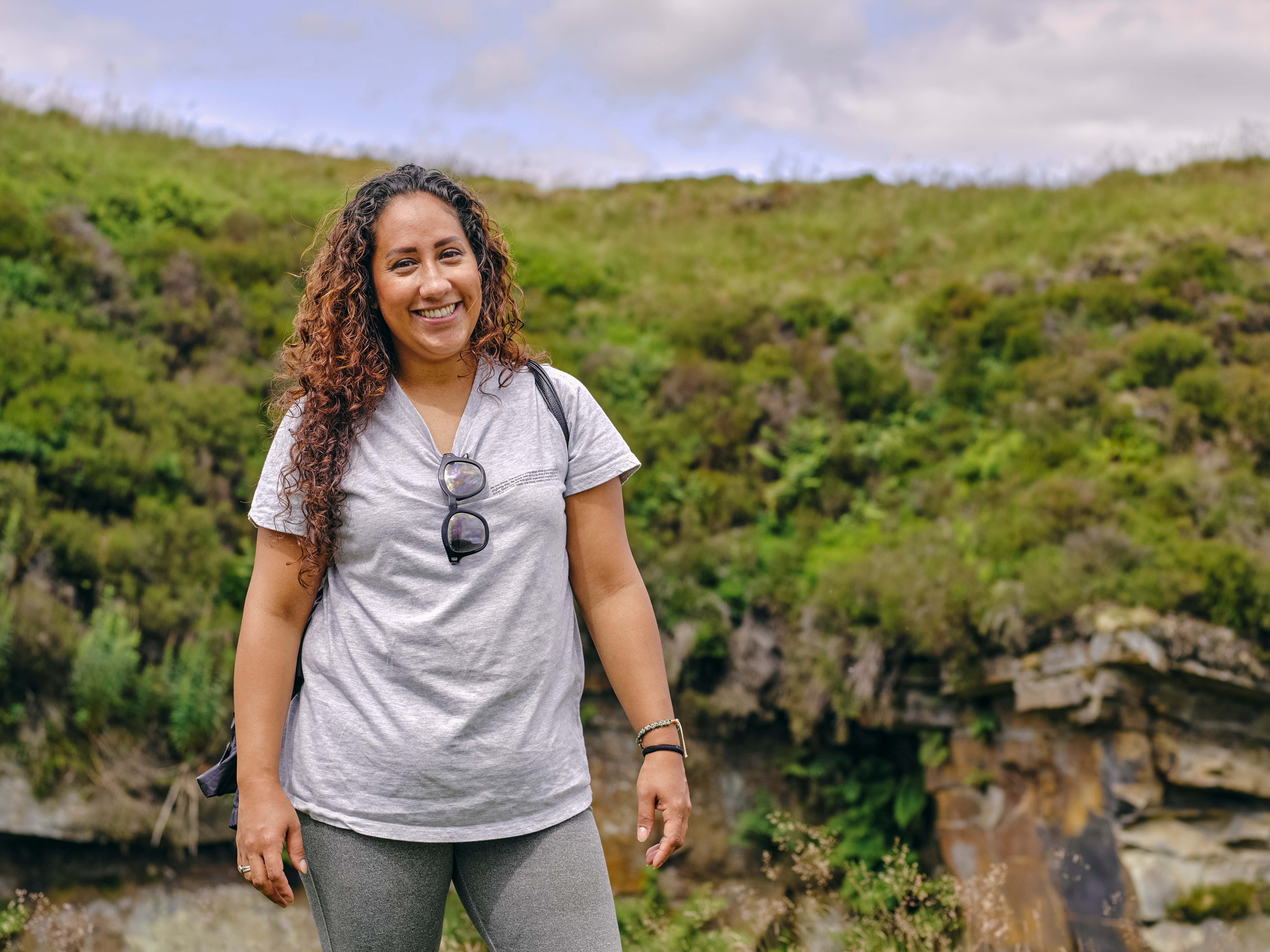 a woman smiles while outdoors on a walk