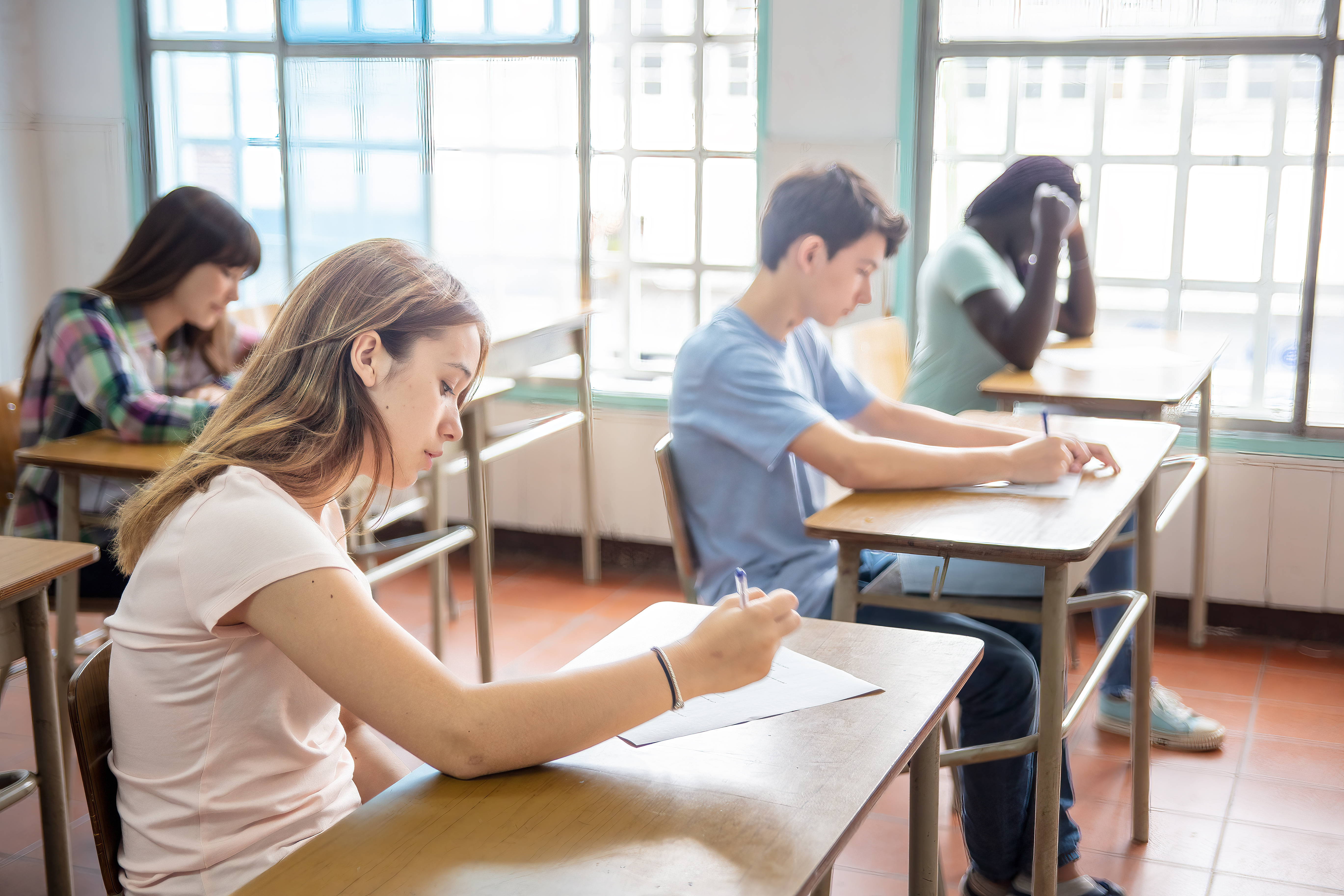 Students sit at desks in a classroom