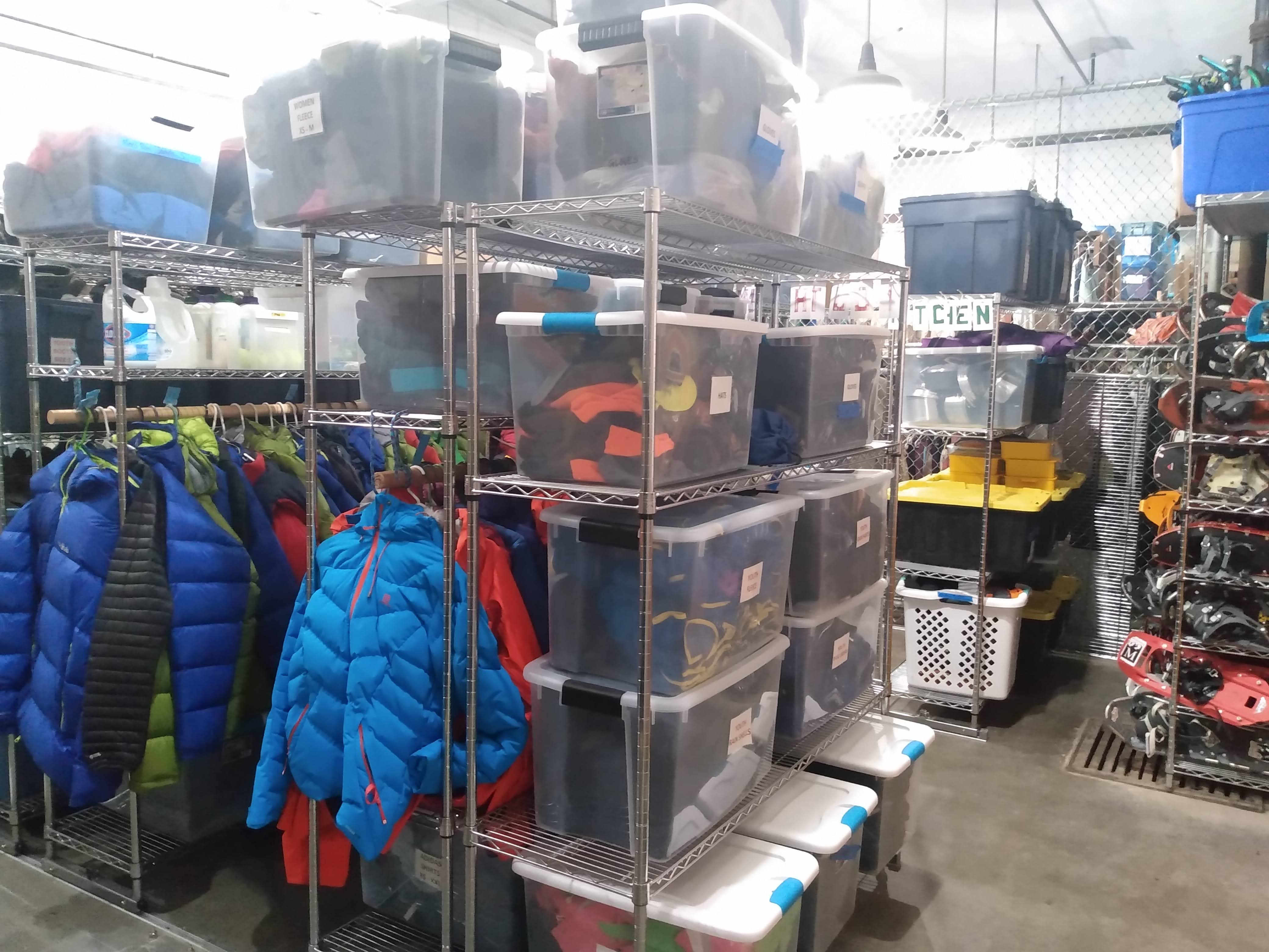 A room is filled with gear stored on shelves and hooks