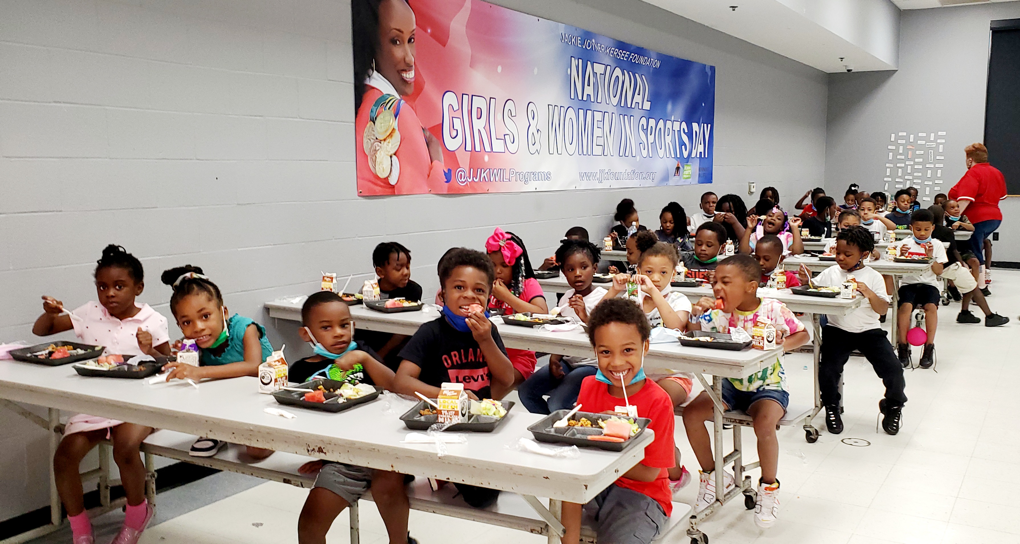 A room of kids eats a snack together