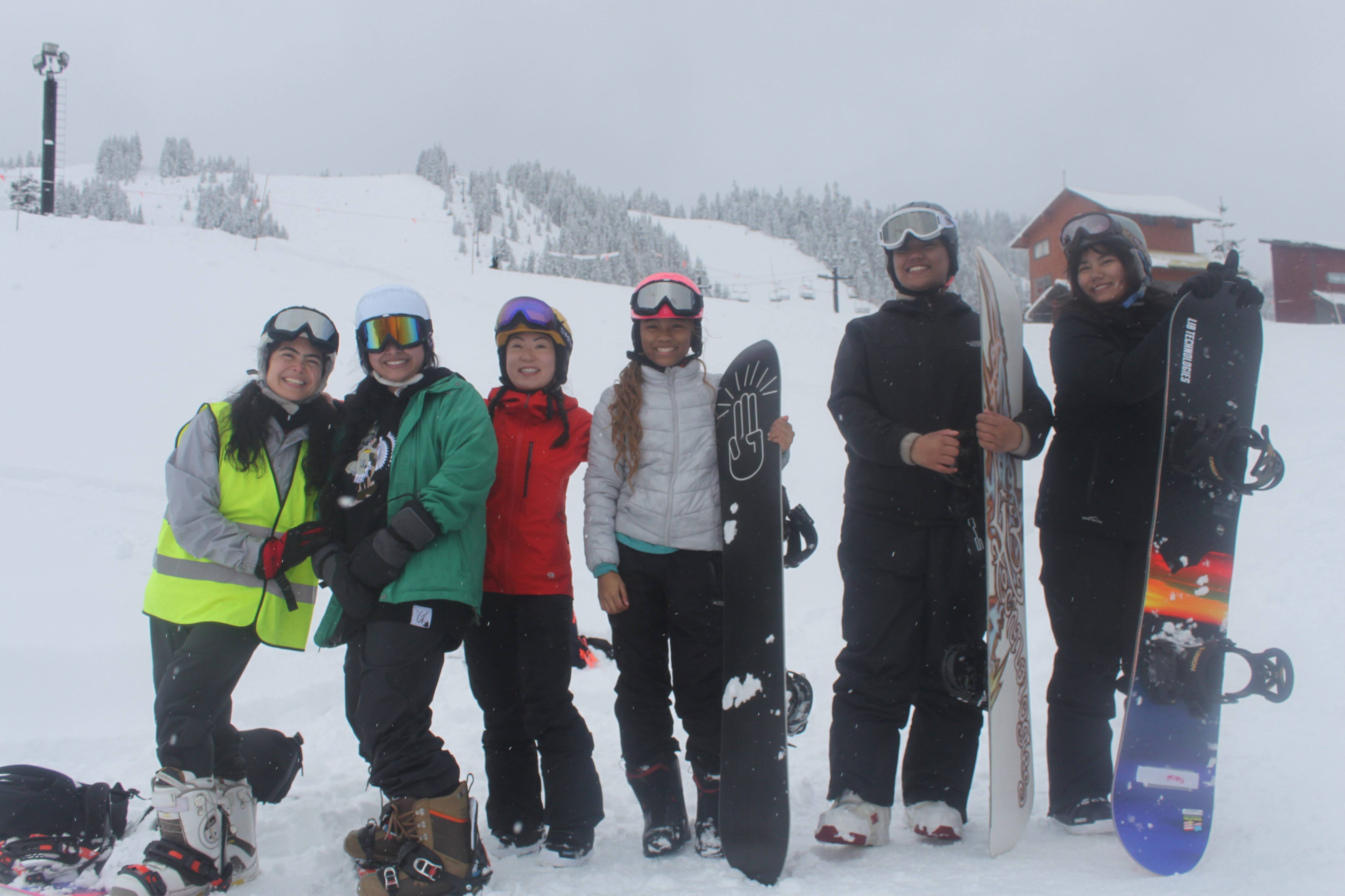 Elders and youth snowboard together