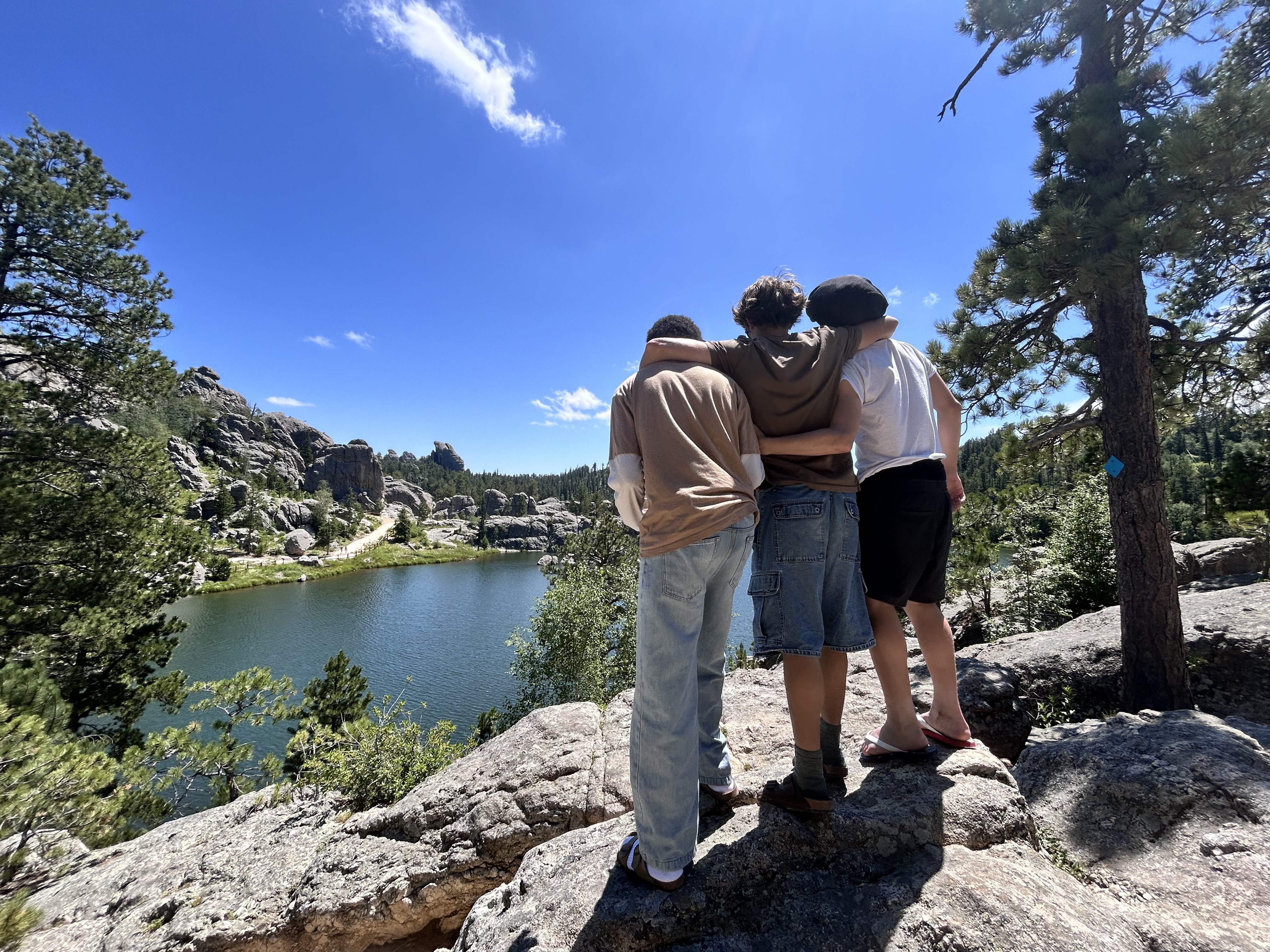 program participants stand with their arms around each other