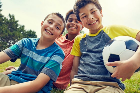 Boys smiling with a soccer ball